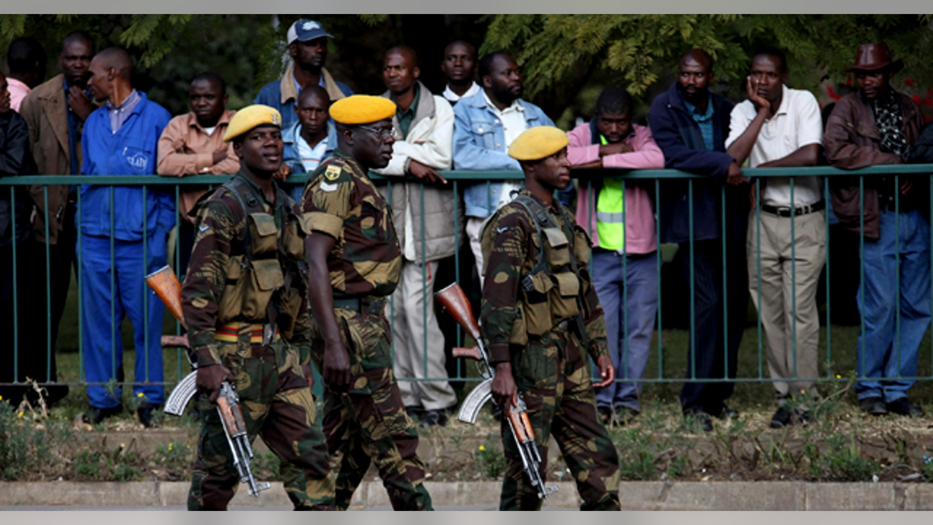 July 14: Members of the Zimbabwe National Army take up positions following the arrival of President Robert Mugabe, for the presentation of the mid term monetary review in Harare. (AP)