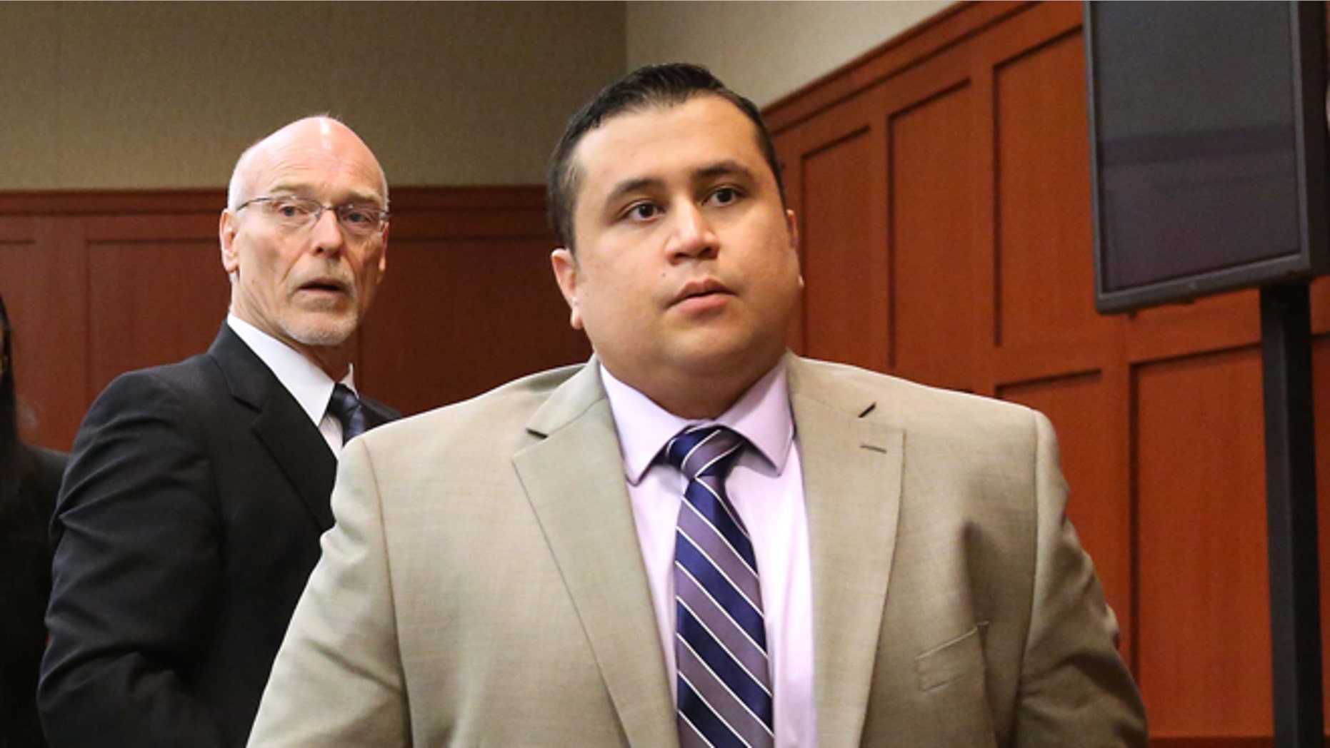 FILE - George Zimmerman, right, and attorney Don West, stand as the judge enters the courtroom in Seminole circuit court for a pretrial hearing, in Sanford, Fla., in this Saturday, June 8, 2013 file photo. Jury selection begins Monday June 10, 2013 in the second-degree murder trial, which is expected to last about six weeks. Martin's killing drew worldwide attention as it sparked a national debate about race, equal justice under the law and gun control. (AP Photo/Orlando Sentinel, Joe Burbank, Pool)