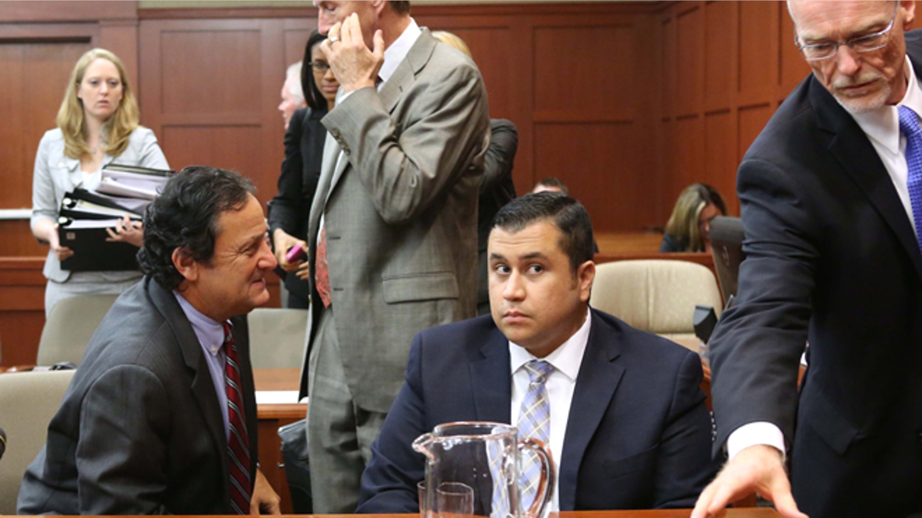 Defense attorney Mark O'Mara, second from left, jury consultant Robert Hirschhorn, left, George Zimmerman and co-counsel Don West, right, chat during a recess in Seminole circuit court during Zimmerman's trial, in Sanford, Fla., Tuesday, June 11, 2013. Zimmerman has been charged with second-degree murder for the 2012 shooting death of Trayvon Martin.(AP Photo/Orlando Sentinel, Joe Burbank, Pool)