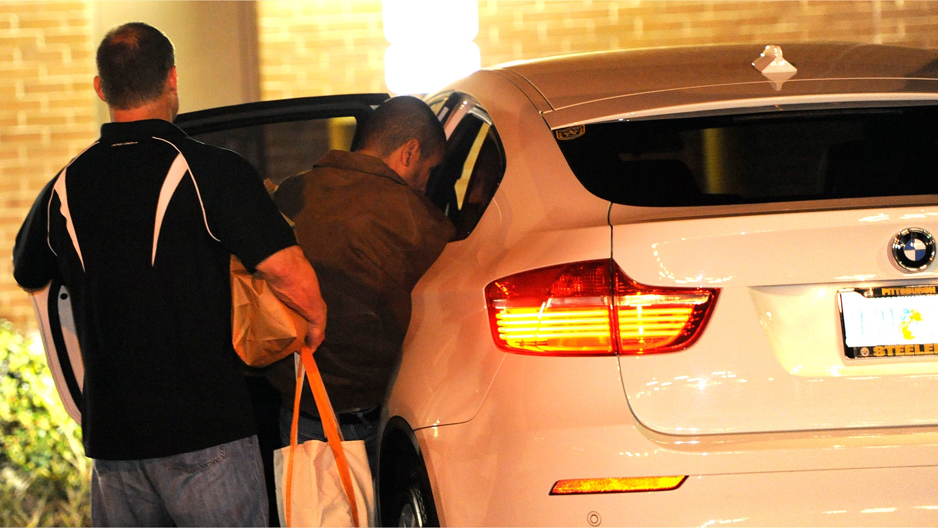 George Zimmerman, right, gets into a vehicle moments after walking out of the intake building at the John E. Polk Correctional Facility with an unidentified man on Sunday in Sanford, Fla. (AP Photo/Brian Blanco)
