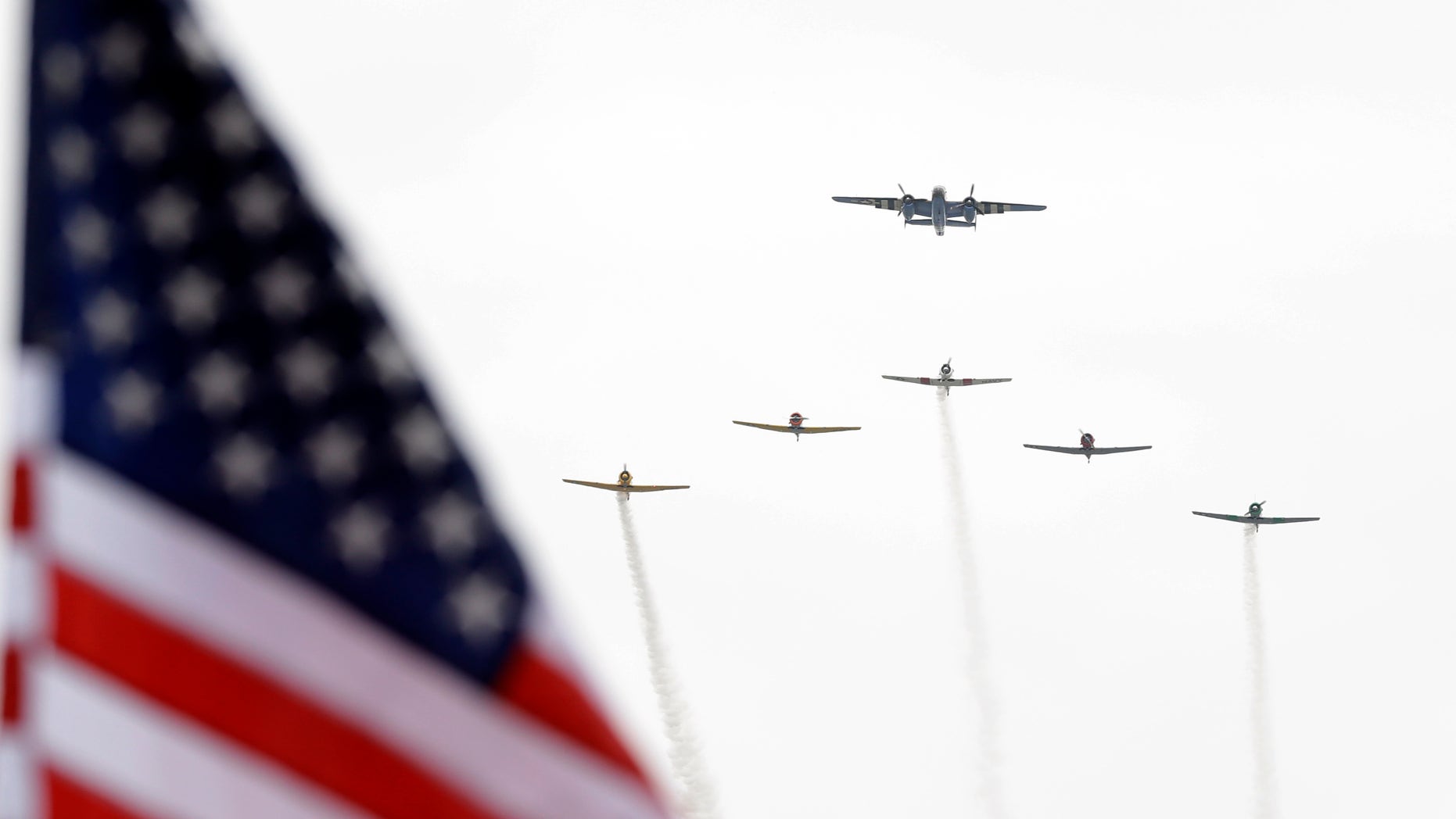 A fly-over of historic war planes during the National Anthem makes it was over the track before the start of the Indianapolis 500 auto race at the Indianapolis Motor Speedway in Indianapolis Sunday, May 26, 2013. (AP Photo/Michael Conroy)