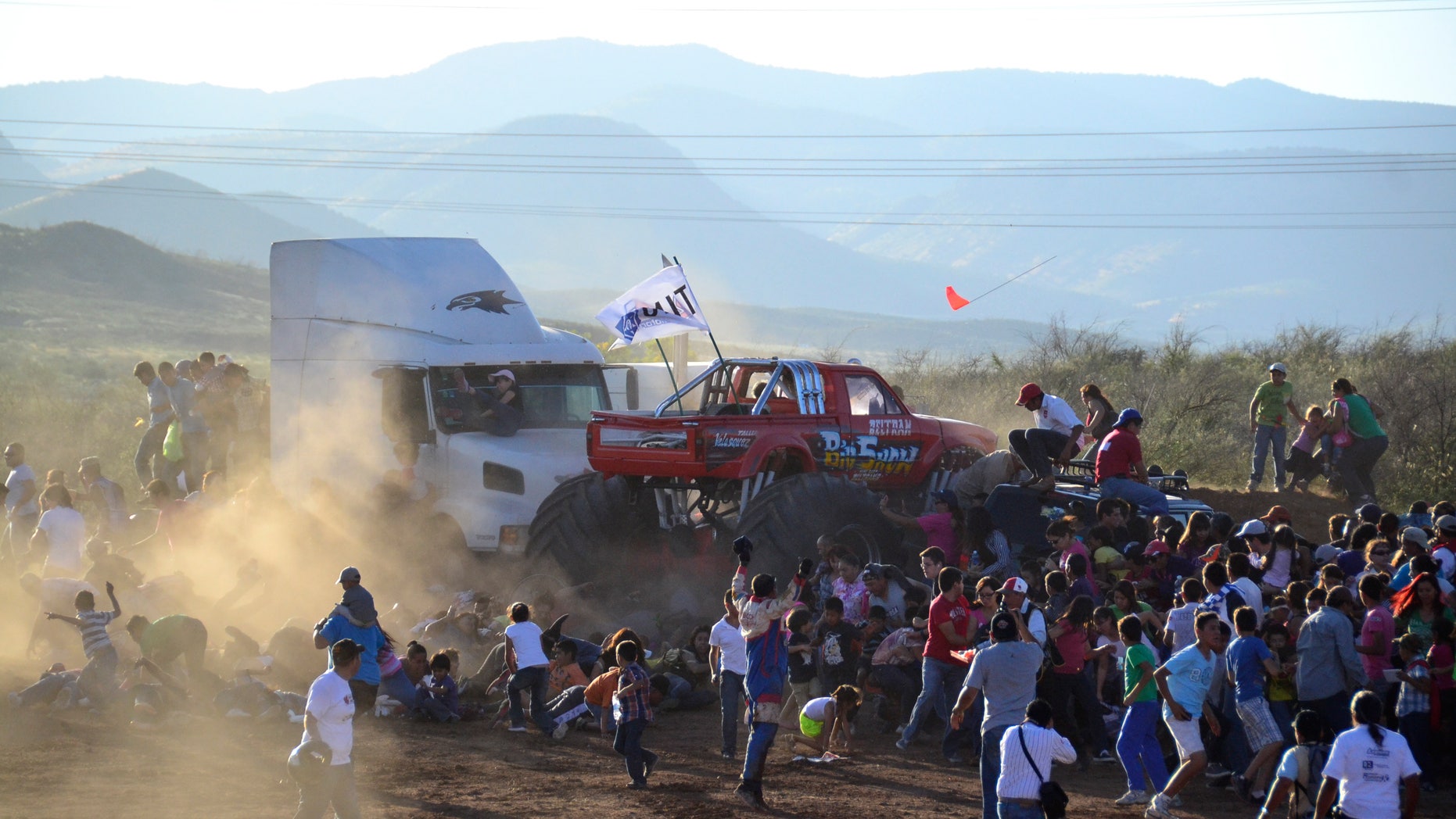 People run as an out of control monster truck plows through a crowd of spectators at a Mexican air show in the city of Chihuahua, Mexico, Saturday Oct. 5, 2013. According to authorities, at least 8 people were killed and 80 were injured. (AP Photo/El Diario de Chihuahua)
