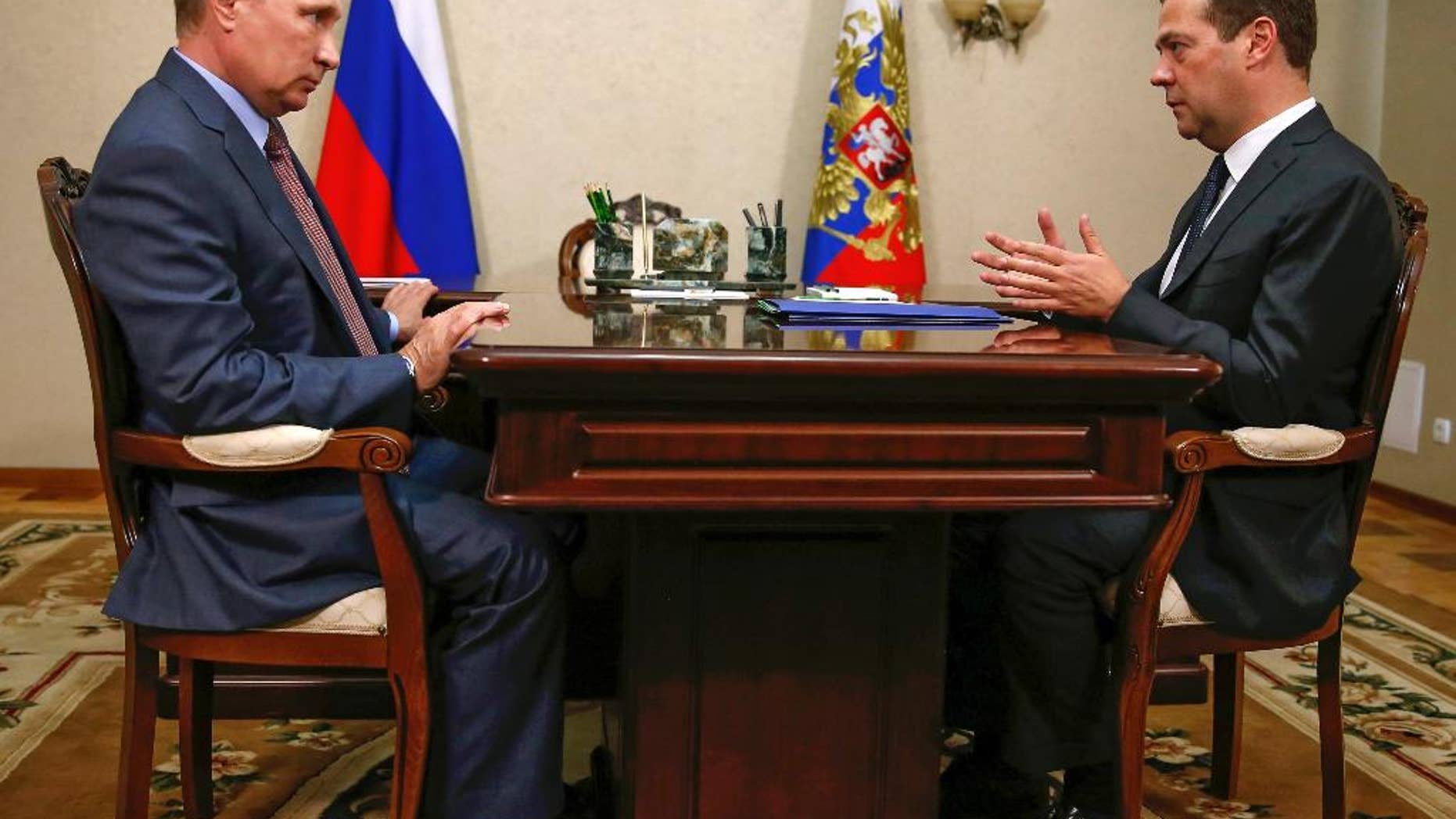 Russian President Vladimir Putin, left, and Prime Minister Dmitry Medvedev meet in Belbek in Crimea, Friday, Aug. 19, 2016. (Dmitry Astakhov/Sputnik, Government Pool Photo via AP)