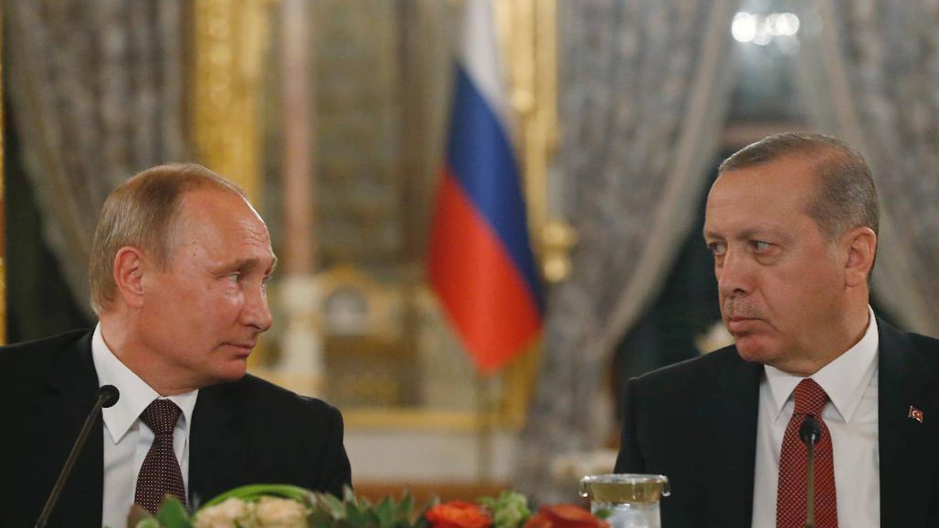 Turkey's President Recep Tayyip Erdogan, right and Russian President Vladimir Putin, left, look at each other during a news conference following their meeting in Istanbul, Monday, Oct. 10, 2016. Putin and Erdogan voiced support for the construction of a gas pipeline from Russia to Turkey, called Turkish Stream, a project that was suspended amid tensions between the two countries. The pipeline would carry Russian natural gas to Turkey and onto European Union countries. (AP Photo/Emrah Gurel)