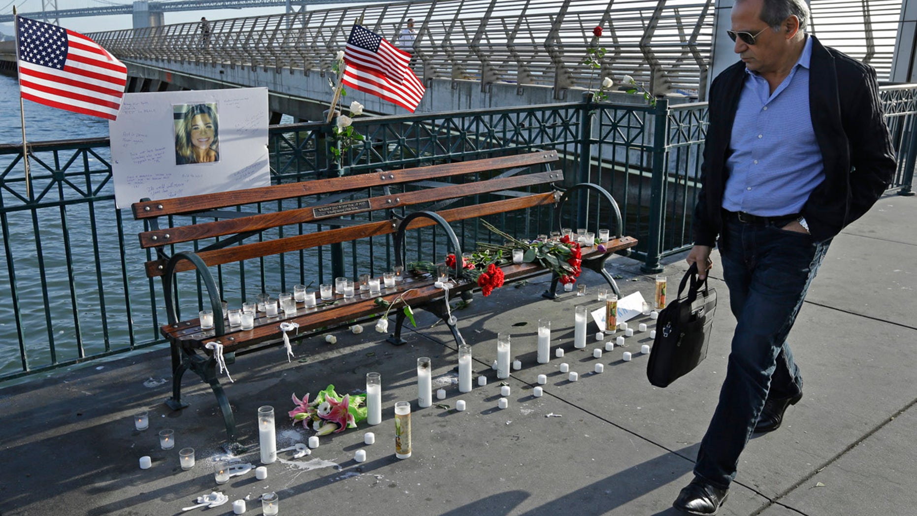Dec. 1: A pedestrian passes the memorial to Kate Steinle at Pier 14 in San Francisco. The city reportedly removed the candles at Steinle's family's request.