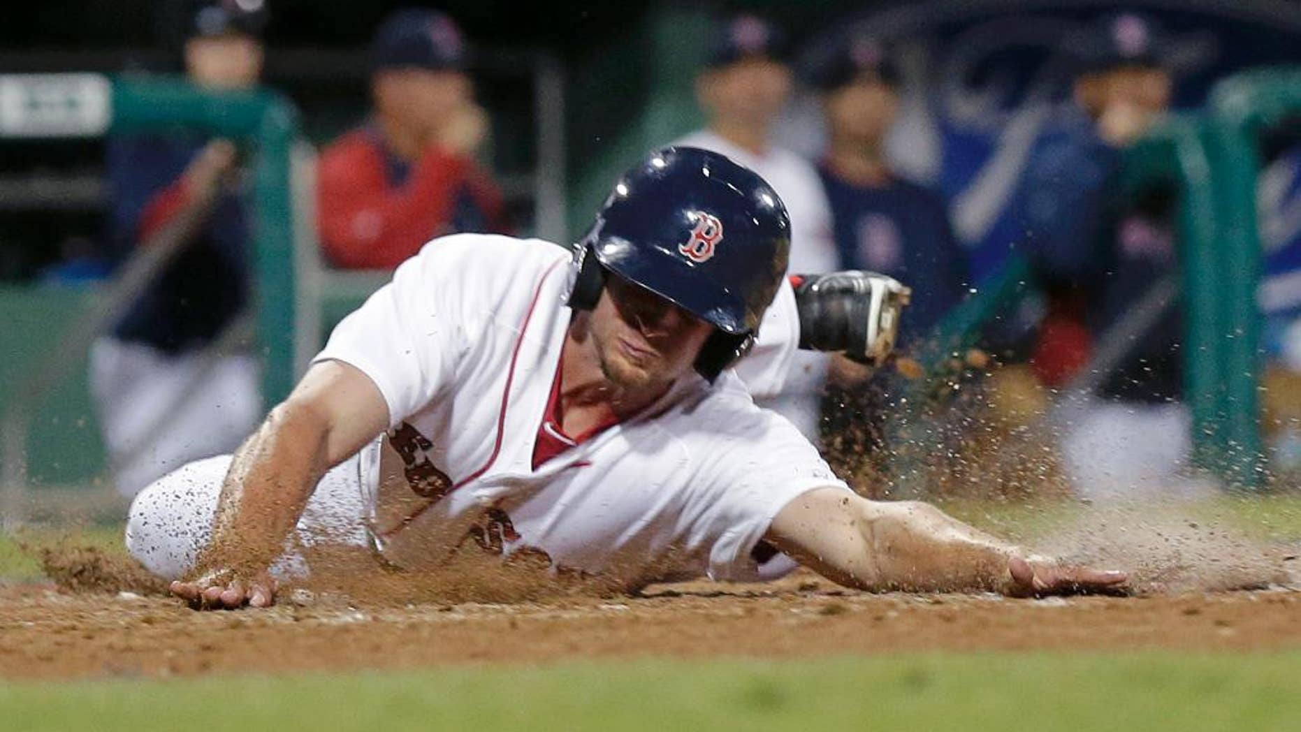 Boston Red Sox Jonathan Roof reaches home on an RBI double by Mike McCoy in the eighth inning of an exhibition baseball game against the Minnesota Twins in Fort Myers, Fla., Thursday, March 27, 2014. The Red Sox won 4-1. (AP Photo/Gerald Herbert)