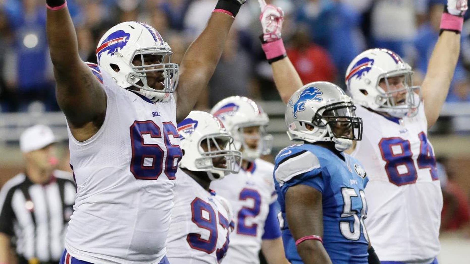 Buffalo Bills tackle Seantrel Henderson (66) celebrates as he watches a 58 -yard game-winning field goal in the fourth quarter of an NFL football game against the Detroit Lions Sunday, Oct. 5, 2014, in Detroit. The Bills defeated the Lions 17-14.(AP Photo/Duane Burleson)