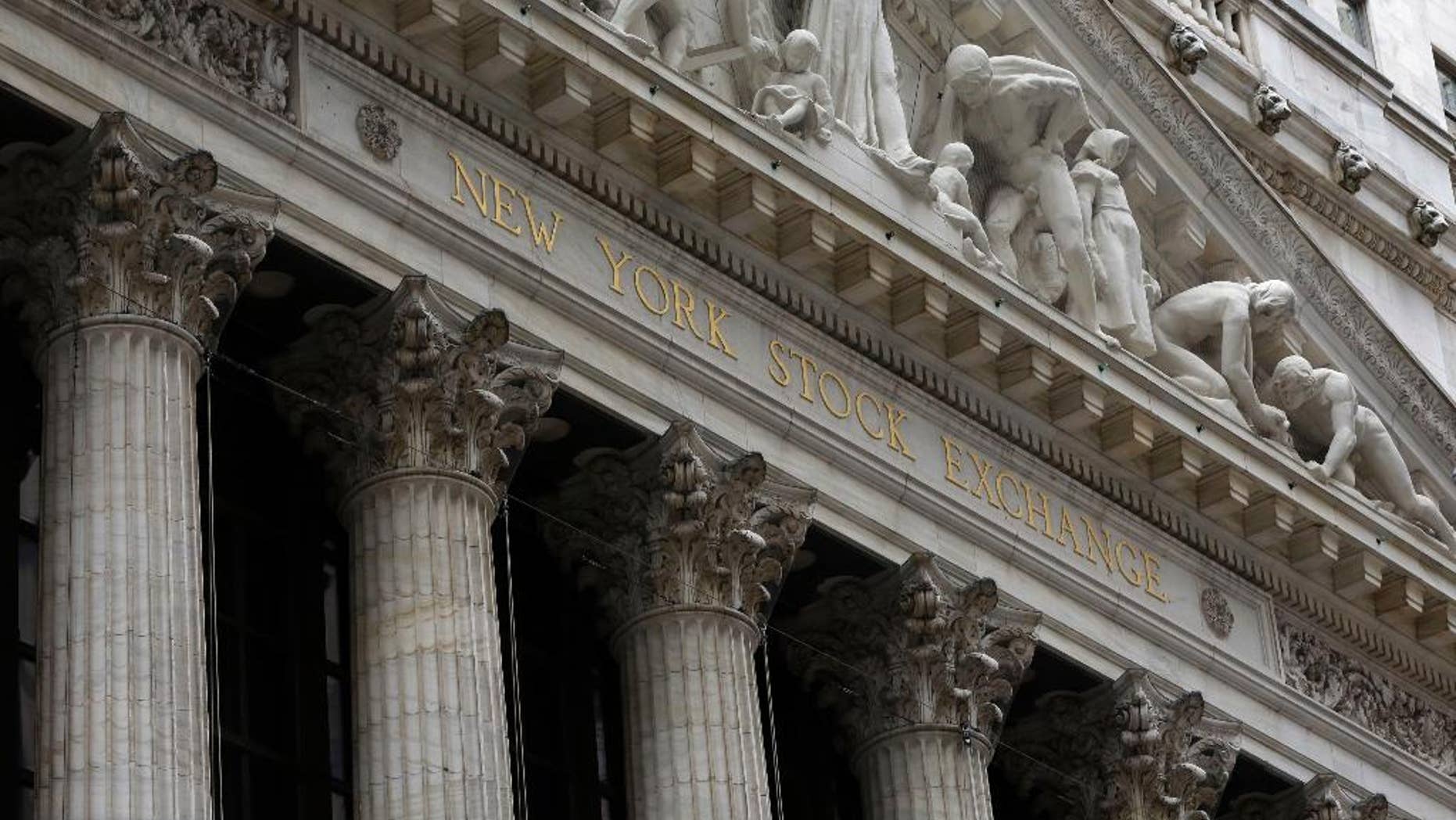 FILE - This Thursday, Oct. 2, 2014, file photo, shows the facade of the New York Stock Exchange. Stock markets turned lower on Wednesday, Feb. 4, 2015, despite upbeat economic data in Europe, while the price of oil's four-day rebound ran out of steam. (AP Photo/Richard Drew, File)