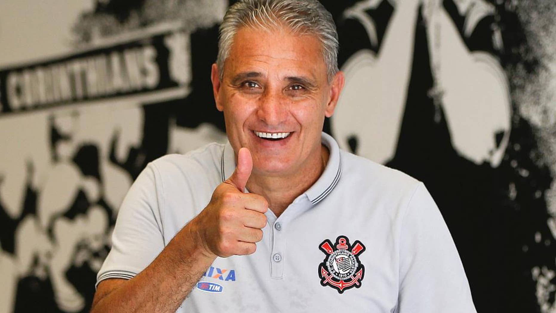 FILE - In this Dec. 5, 2015 file photo, Corinthians soccer coach Adenor Leonardo Bacchi, known as Tite, flashes a thumbs up as he poses after a team training session at the Itaquerao stadium, in Sao Paulo, Brazil. On Wednesday, June 15, 2016, the president of the Corinthians football club announced that Tite, has been named the new coach of Brazil's national team. (AP Photo/Andre Penner, File)