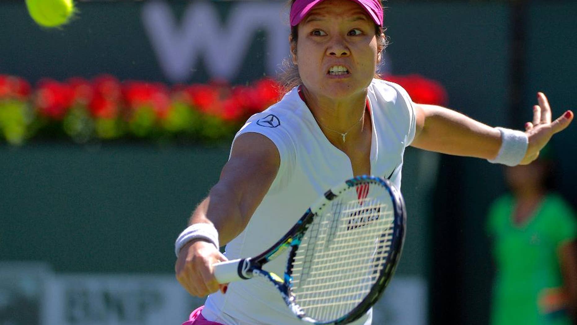 Li Na, of China, returns a volley by Karolina Pliskova, of the Czech Republic, during a third round match at the BNP Paribas Open tennis tournament, Monday, March 10, 2014 in Indian Wells, Calif. (AP Photo/Mark J. Terrill)