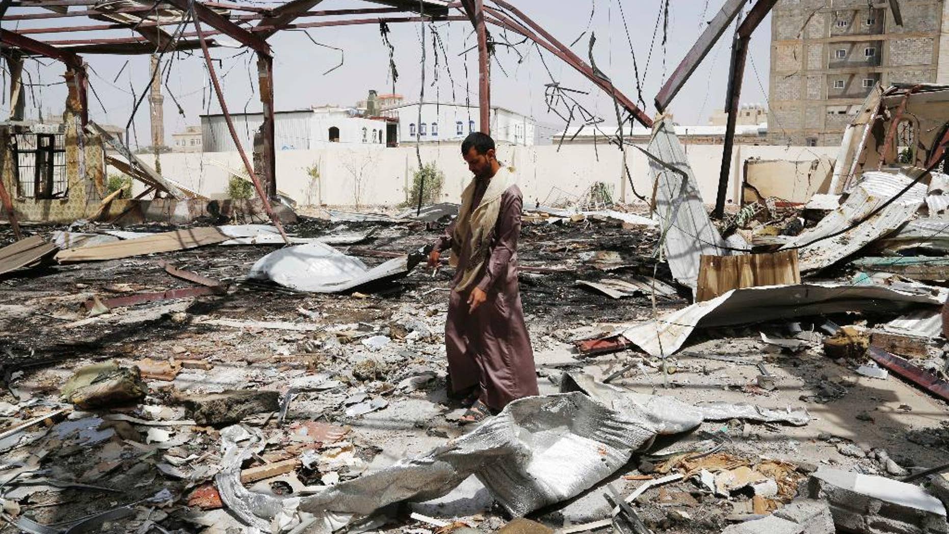A man stands on the rubble of a wedding hall destroyed by a Saudi-led airstrike in Sanaa, Yemen, Friday, July 10, 2015. More than 3,000 people have been killed since March, when a Saudi-led and U.S.-backed coalition began launching airstrikes against the rebels who seized control of the capital and other cities starting September. (AP Photo/Hani Mohammed)