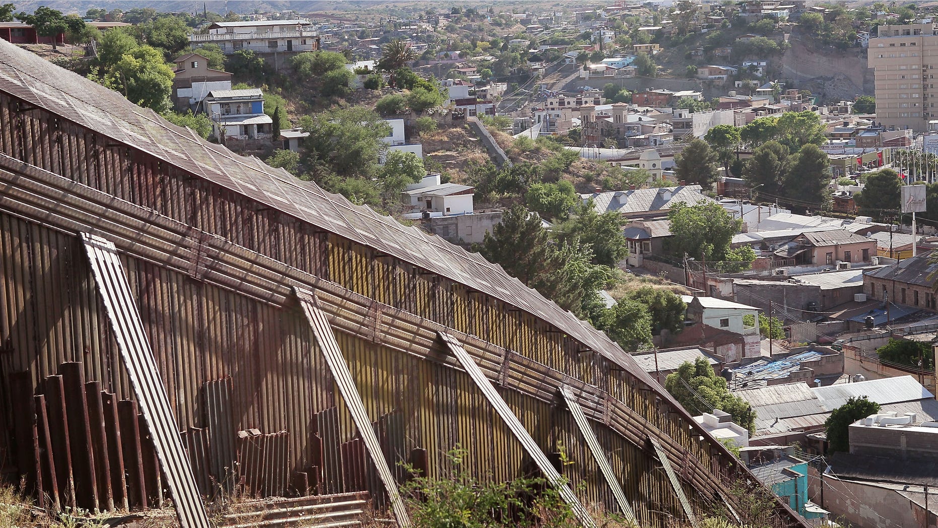 NOGALES, AZ - JUNE 02: A fence separates the cities of Nogales, Arizona and Nogales, Sonora Mexico, a frequent crossing point for people entering the United States illegally, June 2, 2010 in Nogales, Arizona. During the 2009 fiscal year 540,865 undocumented immigrants were apprehended entering the United States illegally along the Mexican border, 241,000 of those were captured in the 262 mile stretch of the border known as the Tucson Sector. (Photo by Scott Olson/Getty Images)