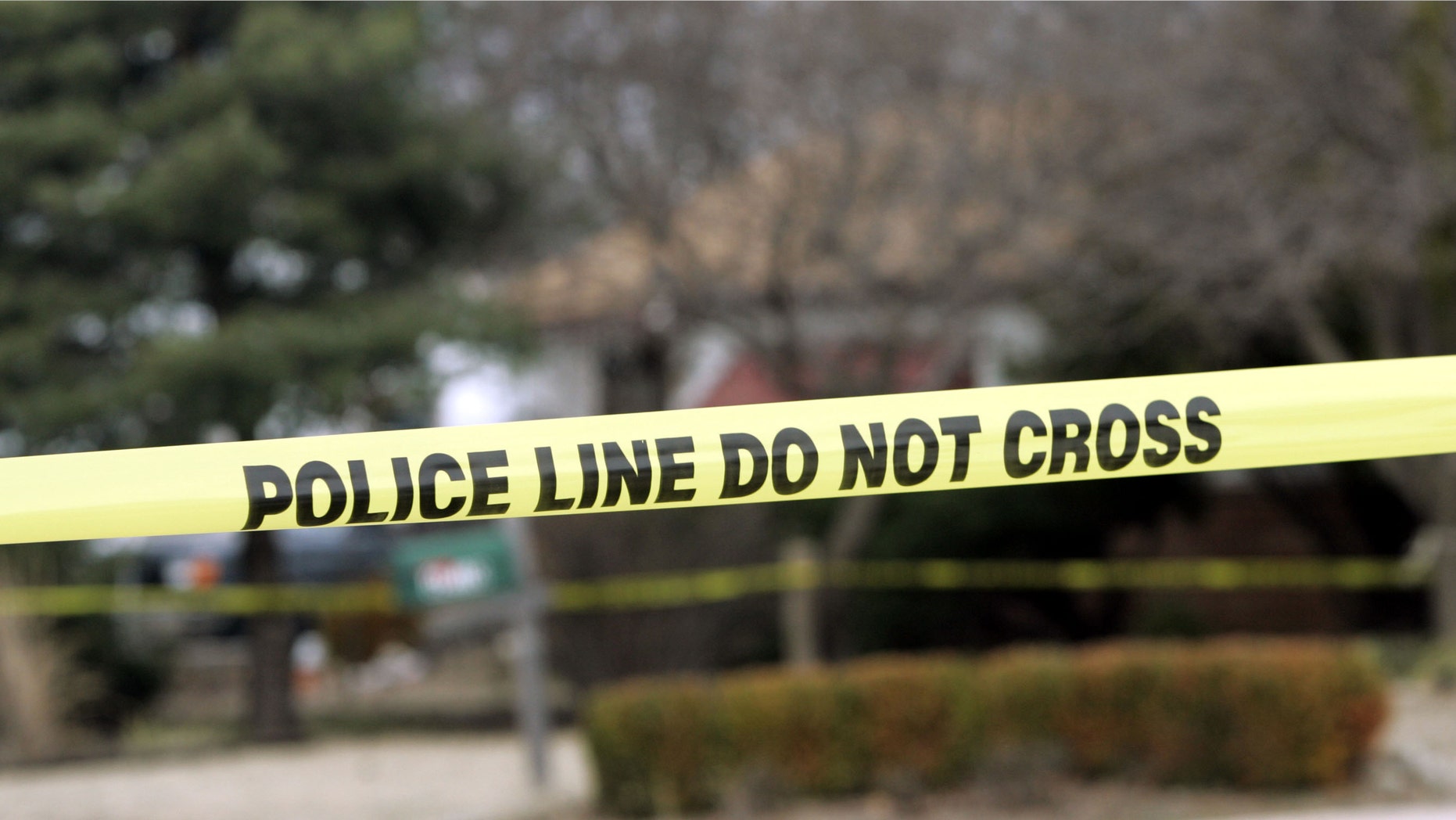 PARK CITY, KS - FEBUARY 26: Police tape hangs across the street in front of the house that Dennis Rader lives in February 26, 2005 in Park City, Kansas. Rader is the suspect whom police have arrested on suspicion of first-degree murder in connection with the 10 deaths now tied to the serial killer known as BTK. (Photo by Larry W. Smith/Getty Images)