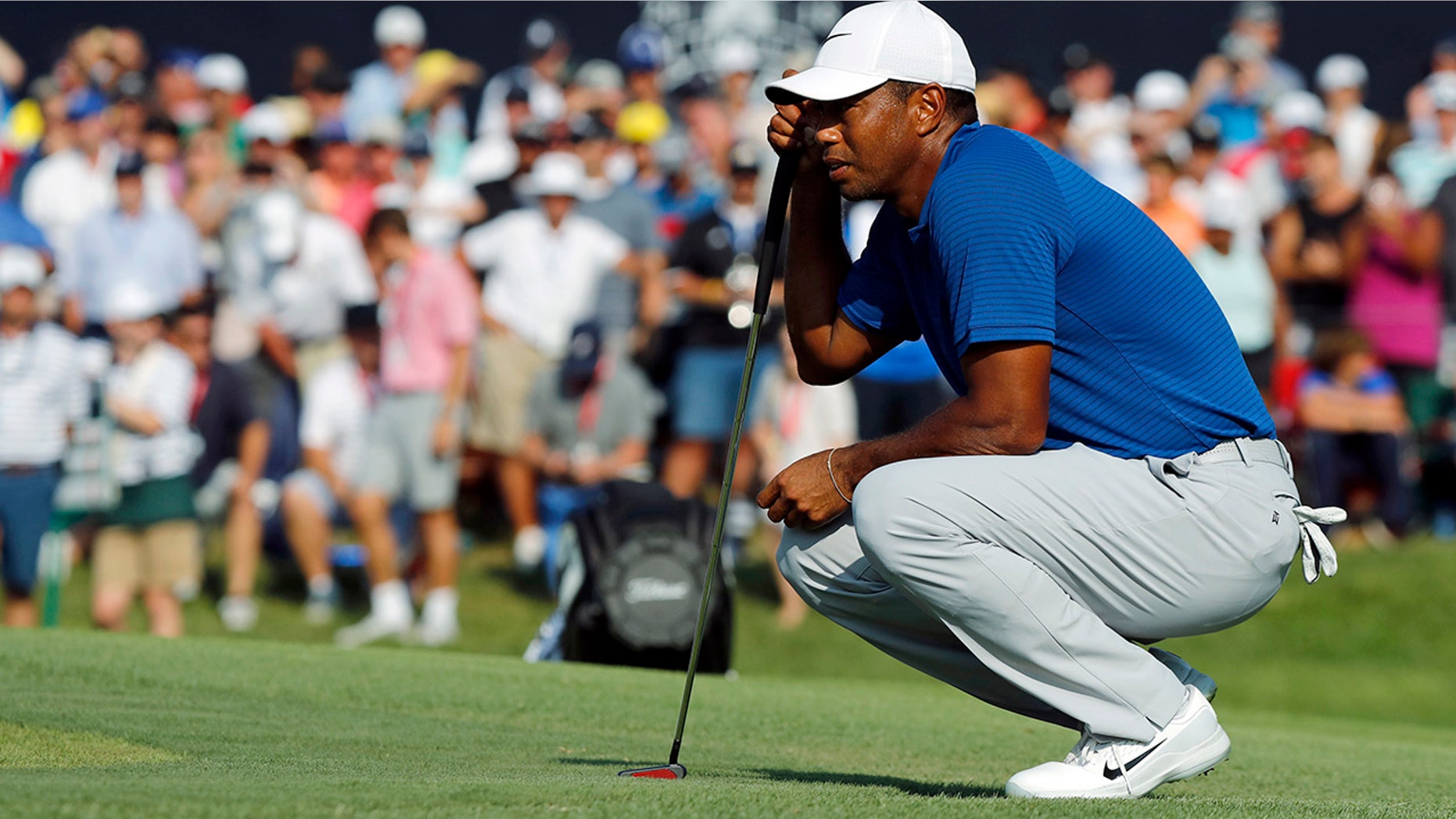 Tiger Woods looks at his putt on the 18th green during the third round of the PGA Championship golf tournament at Bellerive Country Club, St. Luois, Aug. 11, 2018.