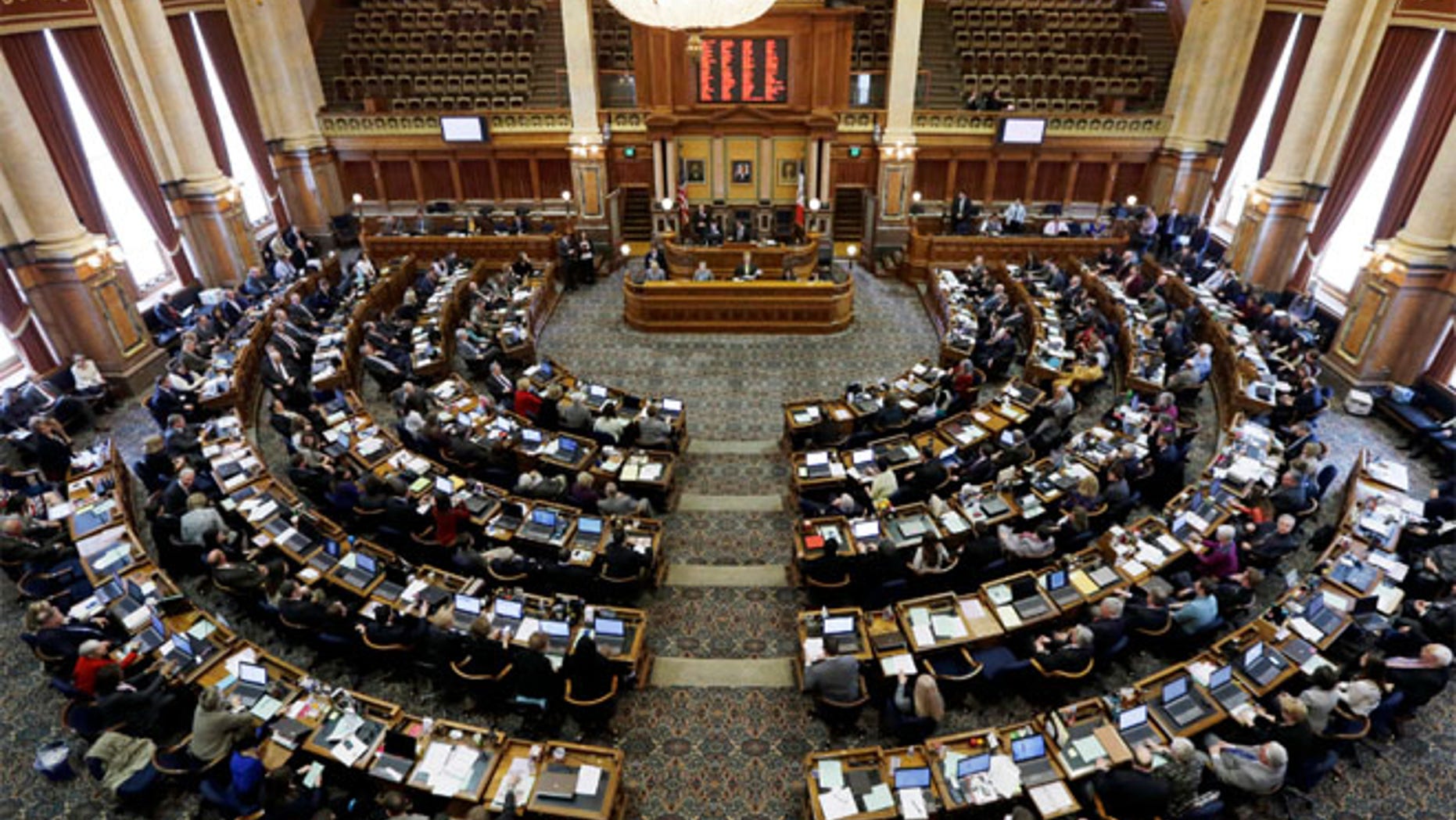 FILE: State representatives work in the Iowa House on the opening day of the Iowa Legislature at the Statehouse in Des Moines, Iowa.