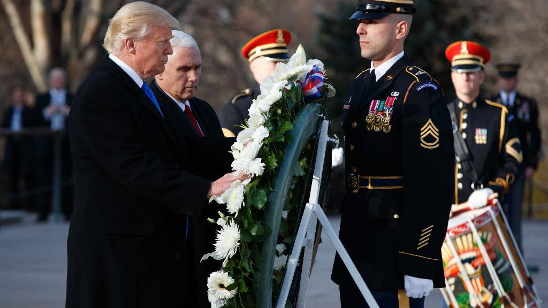 President-elect Donald Trump, accompanied by Vice President-elect Mike Pence places a wreath at the Tomb of the Unknowns, Thursday, Jan. 19, 2017, at Arlington National Cemetery in Arlington, Va., ahead of Friday's presidential inauguration. (AP Photo/Evan Vucci)