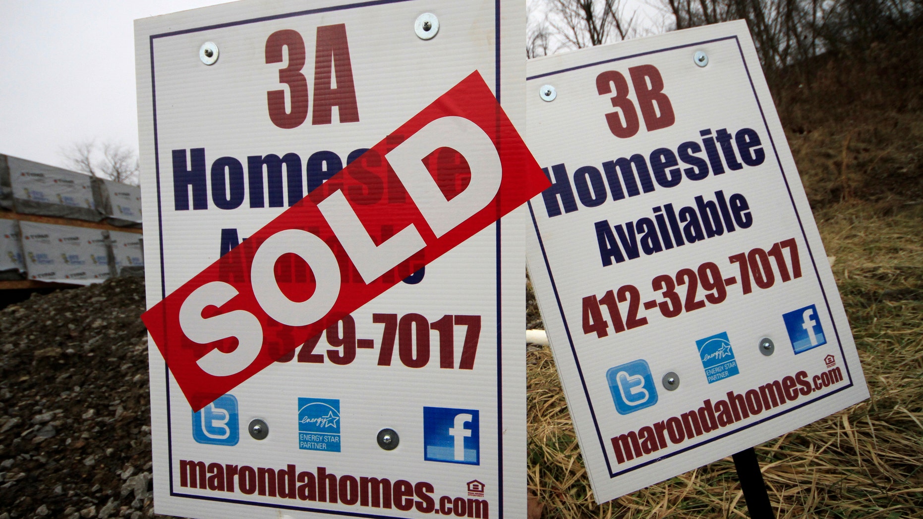 In this Monday, Jan. 13, 2014, photo, a sold sign is placed on a homesite in the Grace Manor townhouse development in Robinson Township, Pa. Freddie Mac, the mortgage company, releases weekly mortgage rates on Thursday, Jan. 23, 2014. (AP Photo/Gene J. Puskar)