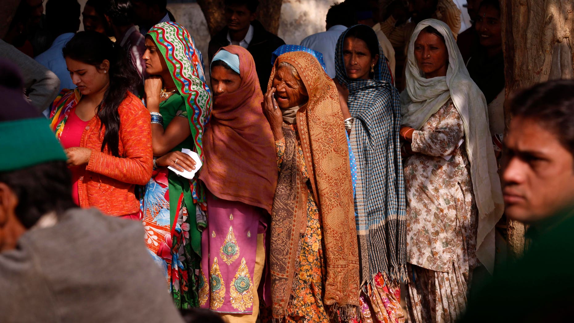 People wait in queues to cast their votes in New Delhi, India, Wednesday, Dec. 4, 2013. Nearly 12 million residents were expected to vote to select the assembly, in a poll that analysts say is expected to show a trend for the three parties heading into next year's national elections in the world's biggest democracy. (AP Photo/Saurabh Das)