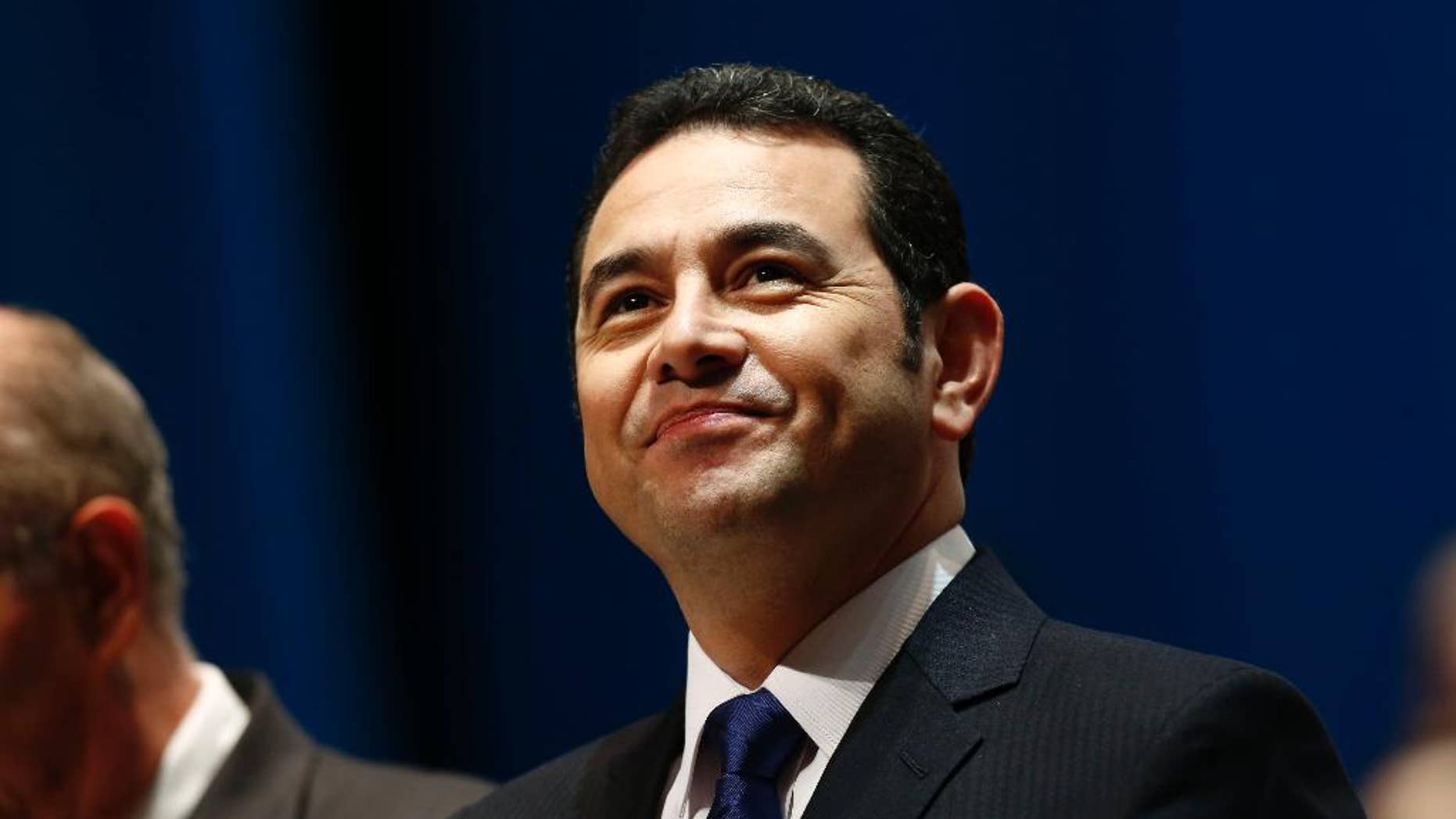 FILE - In this Jan. 14, 2016, file photo, Guatemala's President Jimmy Morales arrives for his inauguration ceremony at the National Theater in Guatemala City. The son and brother of Morales have made statements to prosecutors investigating the misappropriation of funds, on Tuesday, Sept. 13. President Morales says both made their statement in person at the Attorney General's Office. (AP Photo/Moises Castillo, File)
