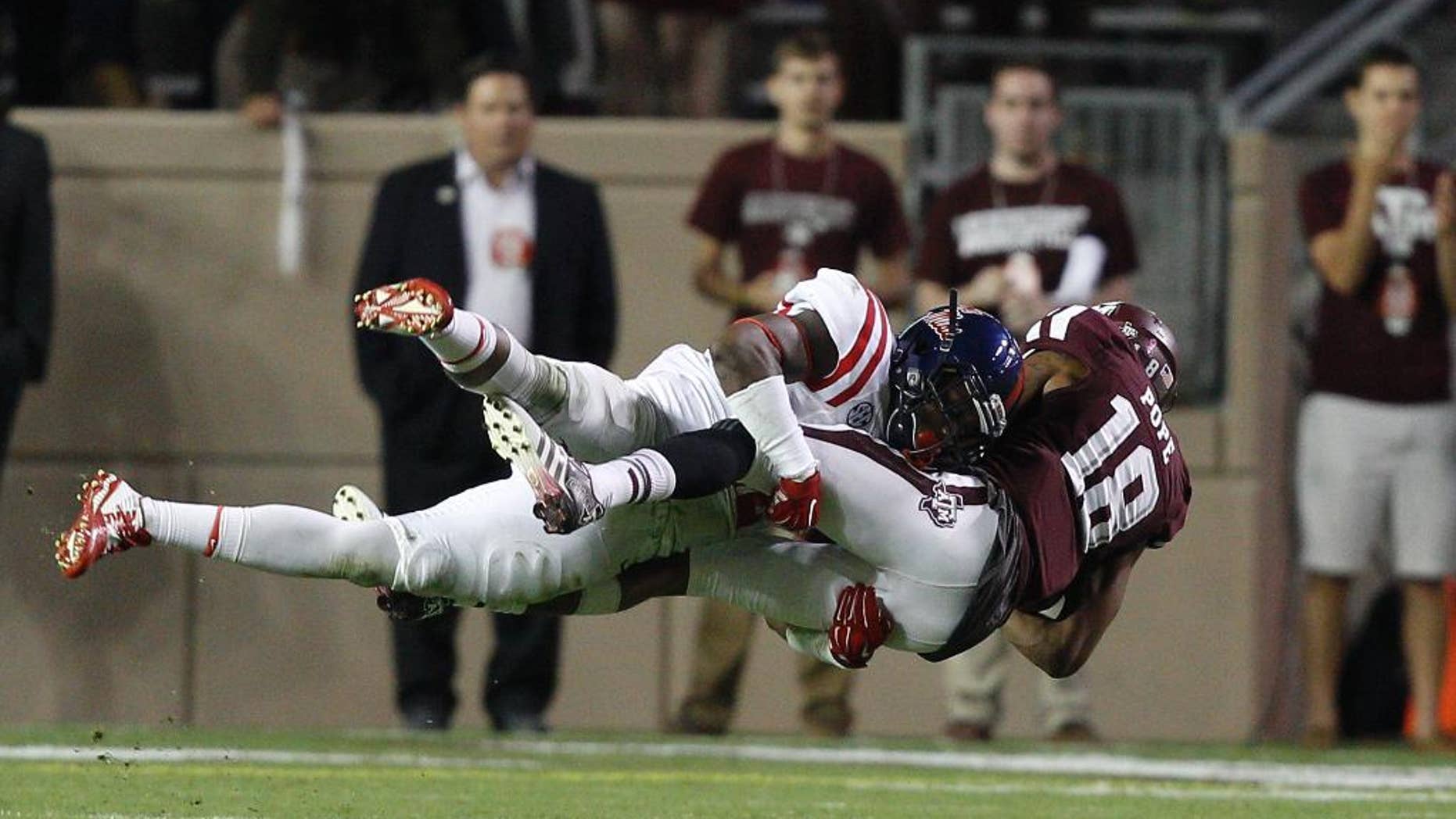 Texas A&M wide receiver Edward Pope (18) is tackled by Mississippi defensive back Tony Conner (12) during the third quarter of an NCAA college football game Saturday, Oct. 11, 2014, in College Station, Texas. (AP Photo/Bob Levey)