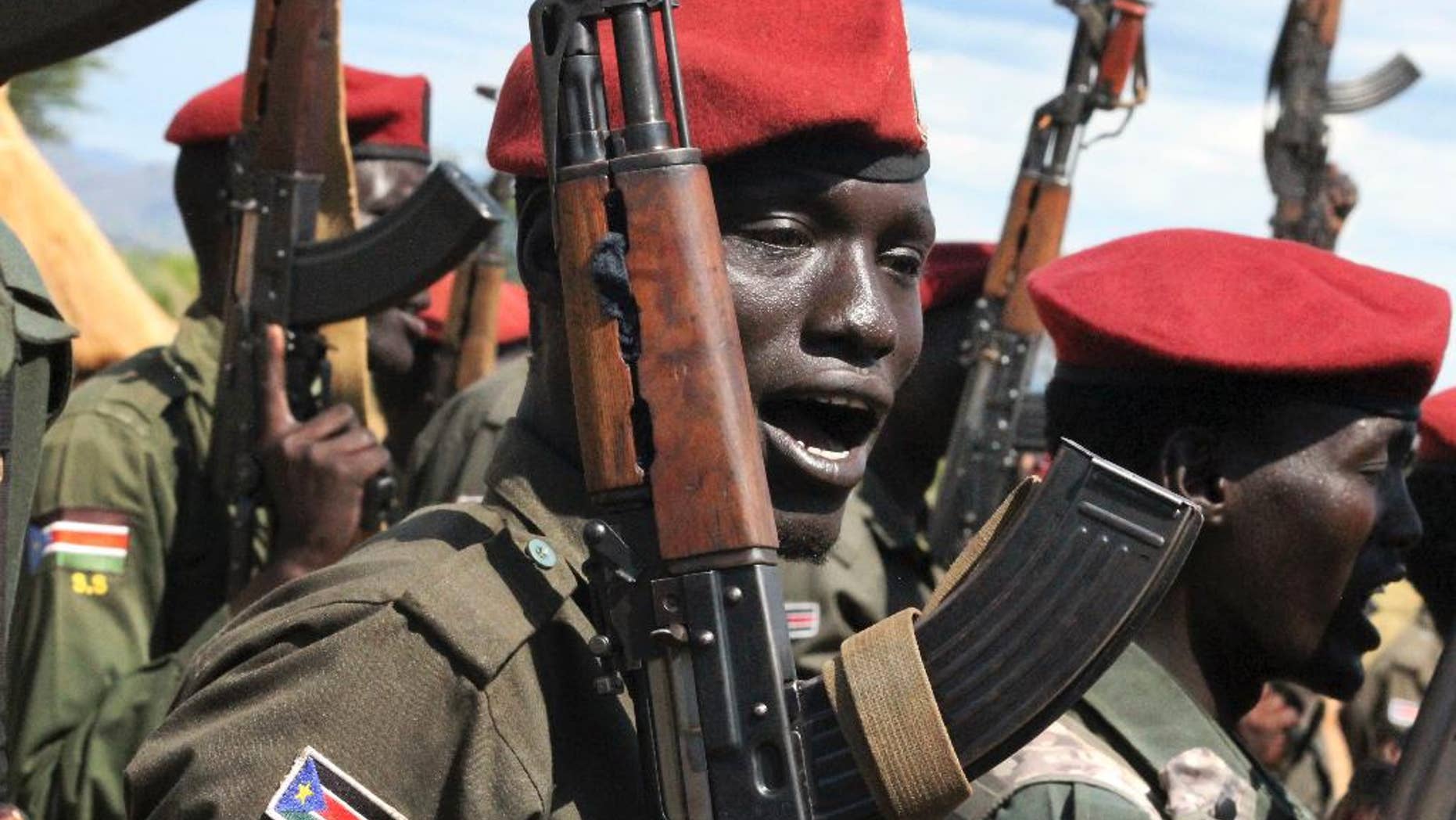 File - In this file photo taken Thursday, April 14, 2016, government soldiers follow orders to raise their guns during a military parade in Juba, South Sudan. Escalating violence in South Sudan is casting a light on Israel’s murky involvement in that raging conflict, with the government's use of Israeli arms and surveillance equipment drawing criticism from human rights activists and a lawmaker who are demanding that Israel halt such transfers to the embattled African country. The scrutiny comes as Israel has been forging new ties with countries across Africa, hoping their support will counter Palestinian diplomatic offensives at the United Nations.(AP Photo/Justin Lynch, File)