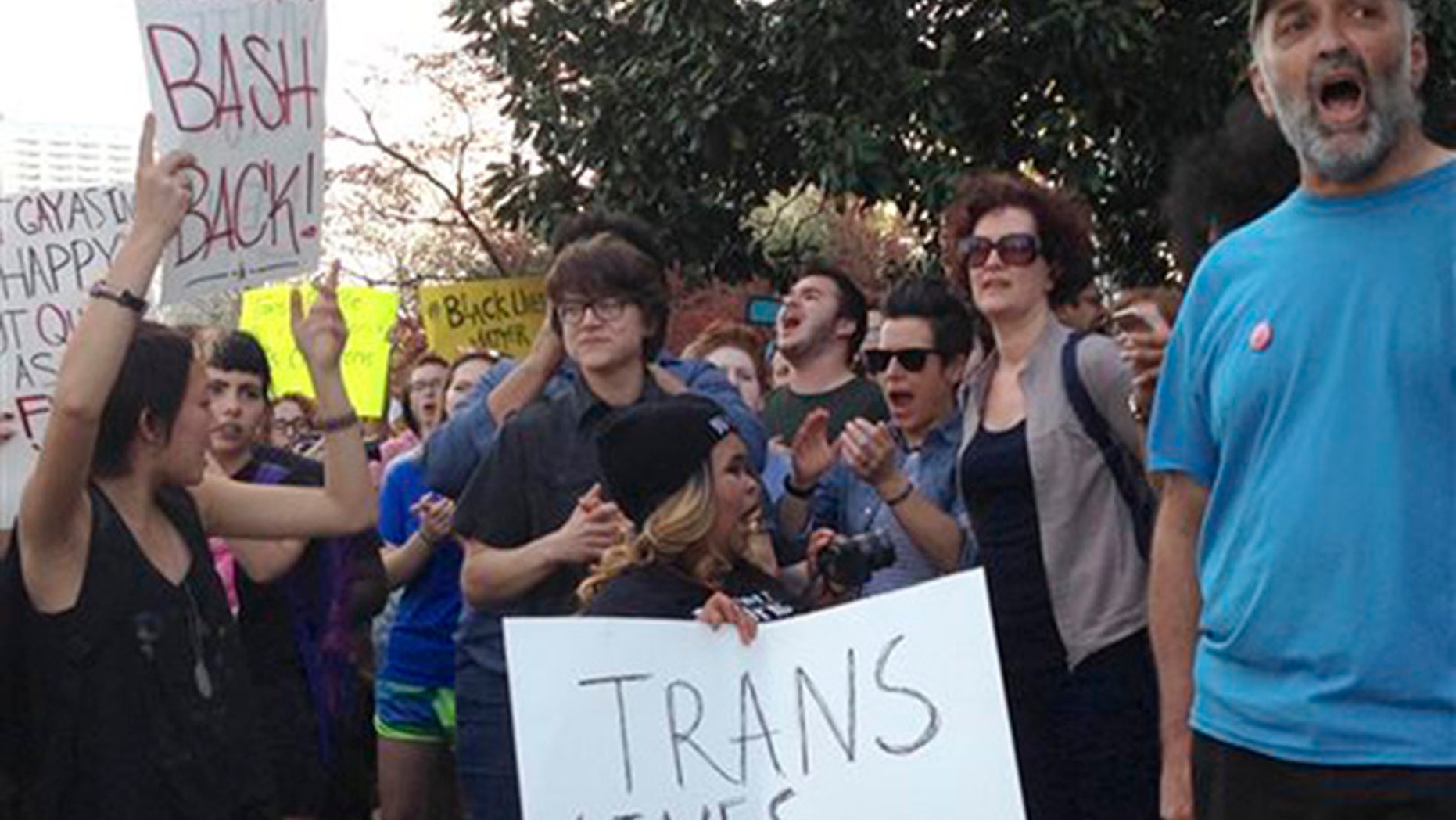 People protest outside the North Carolina Executive Mansion in Raleigh, N.C., Thursday, March 24, 2016. North Carolina legislators decided to rein in local governments by approving a bill Wednesday that prevents cities and counties from passing their own anti-discrimination rules. North Carolina Gov. Pat McCrory later signed the legislation, which dealt a blow to the LGBT movement after success with protections in cities across the country. (AP Photo/Emery P. Dalesio)