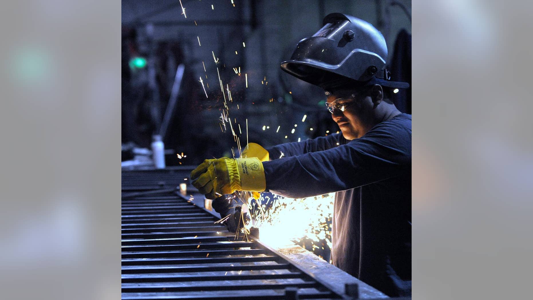 In this photo taken June 11, 2015, machinist Angel Altamirano, 32, of River Rouge, grinds a guardrail for a staircase in Detroit. The Institute for Supply Management, a trade group of purchasing managers, issues its index of manufacturing activity for June on Wednesday, July 1, 2015. (Todd McInturf /The Detroit News via AP) DETROIT FREE PRESS OUT; HUFFINGTON POST OUT