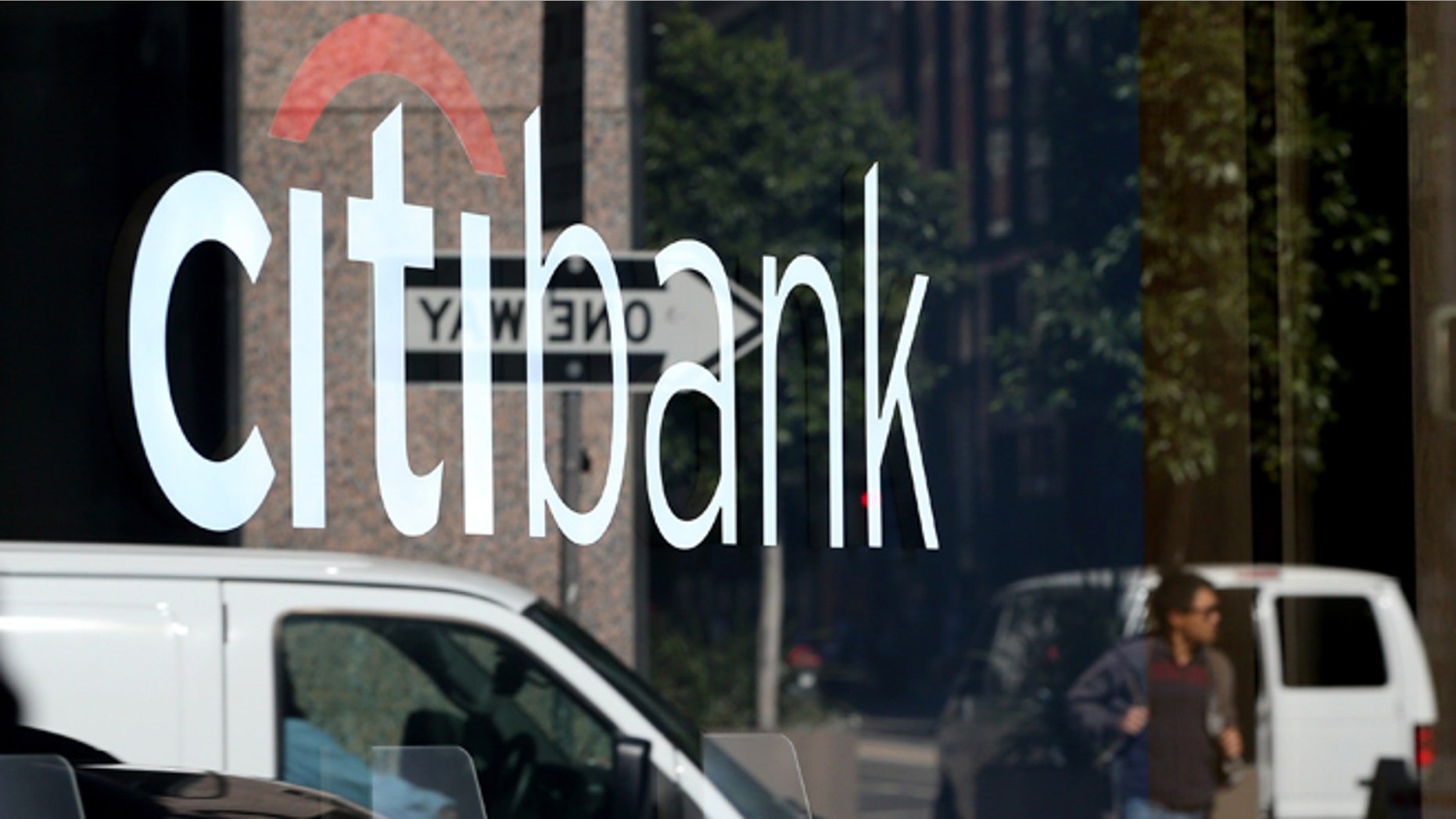 SAN FRANCISCO, CA - JULY 14: A person is reflected in the window of a Citibank branch office on July 14, 2014 in San Francisco, California. After several months of negotiations with the U.S. Department of Justice, Citigroup has agreed to pay nearly $7 billion in fines for misleading investors about the quality of mortgage-backed securities prior to the 2008 financial crisis. As part of the settlement Citigroup will pay $2.5 billion in consumer relief. (Photo by Justin Sullivan/Getty Images)