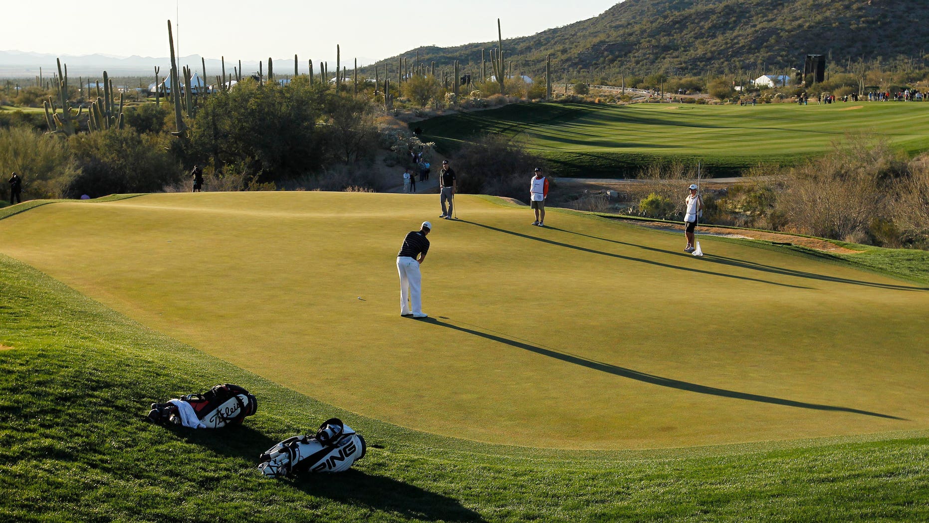 Webb Simpson putts on the 18th green in the quarterfinal round of play against Hunter Mahan during the Match Play Championship golf tournament, Saturday, Feb. 23, 2013, in Marana, Ariz. Mahan won 1-up. (AP Photo/Ross D. Franklin)