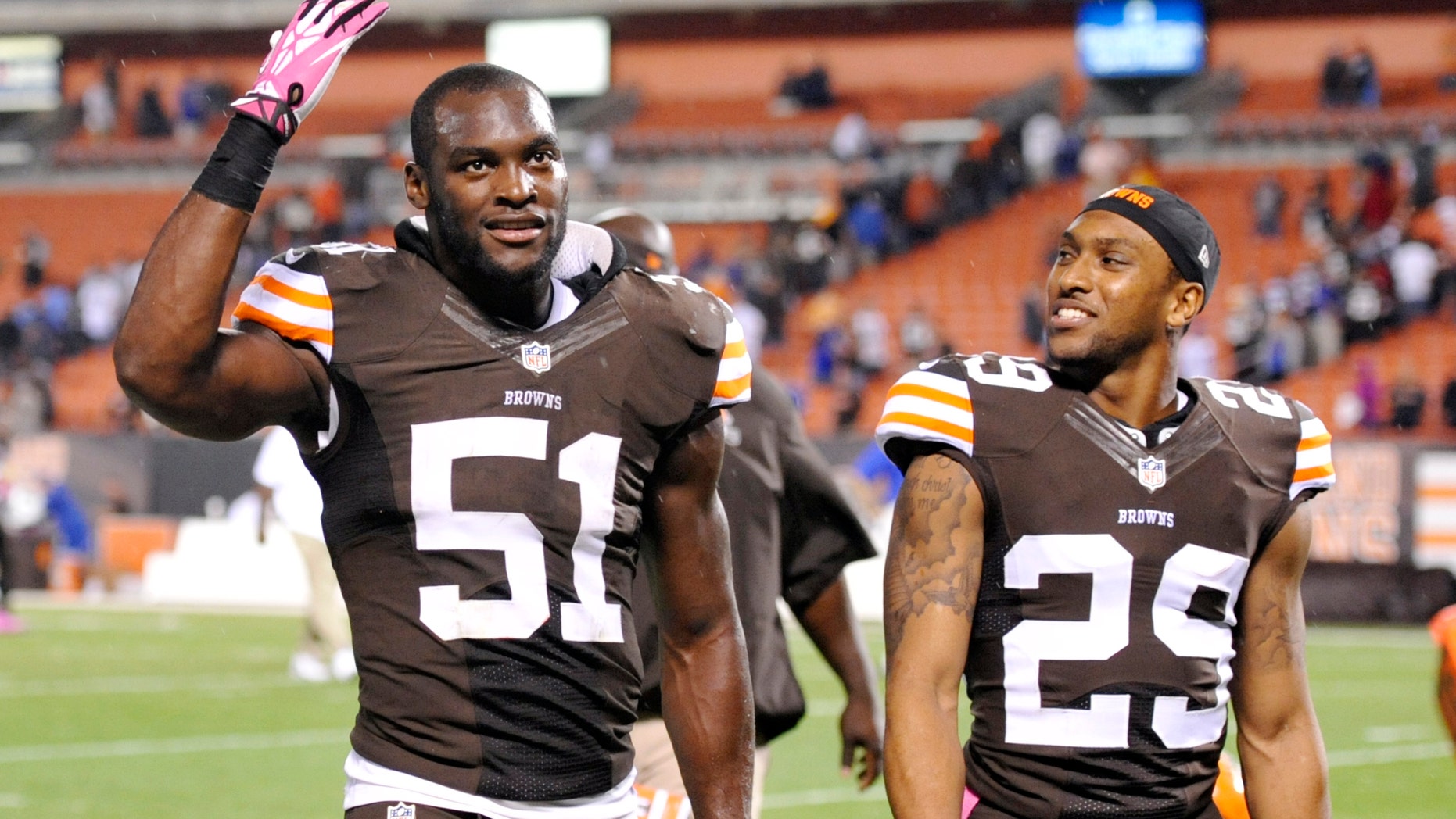Cleveland Browns outside linebacker Barkevious Mingo (51) and cornerback Leon McFadden (29) celebrate after a 37-24 win over the Buffalo Bills in an NFL football game Thursday, Oct. 3, 2013, in Cleveland. (AP Photo/David Richard)