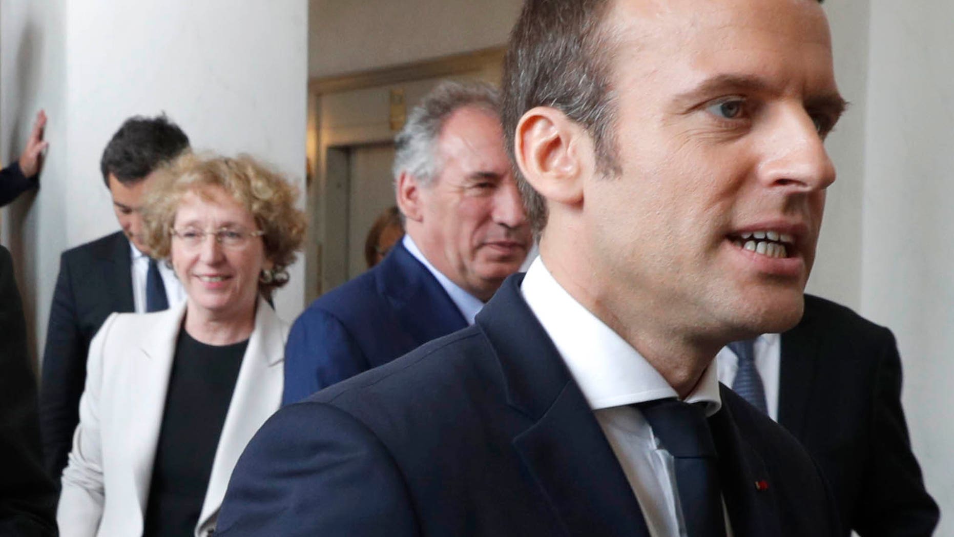 French President Emmanuel Macron,right , and Prime Minister Edouard Philippe, left, leave after a family photo following the first cabinet meeting at the Elysee Palace in Paris, Thursday, May 18, 2017. (Philippe Wojazer, Pool via AP)