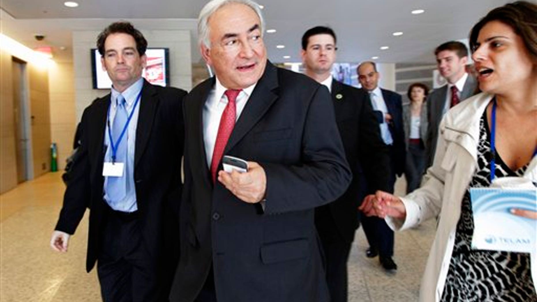 In this April 15, 2011, photo, International Monetary Fund Managing Director Dominique Strauss-Kahn, center, walks to a meeting of the G-20 finance ministers and central bank governors at the 2011 Spring Meetings of the IMF and World Bank in Washington. (AP)