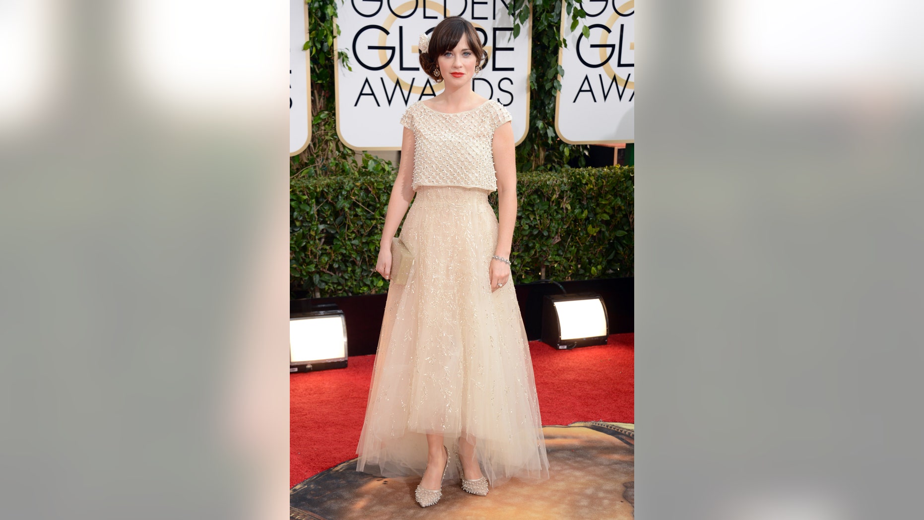 Zooey Deschanel arrives at the 71st annual Golden Globe Awards at the Beverly Hilton Hotel on Sunday, Jan. 12, 2014, in Beverly Hills, Calif. (Photo by Jordan Strauss/Invision/AP)