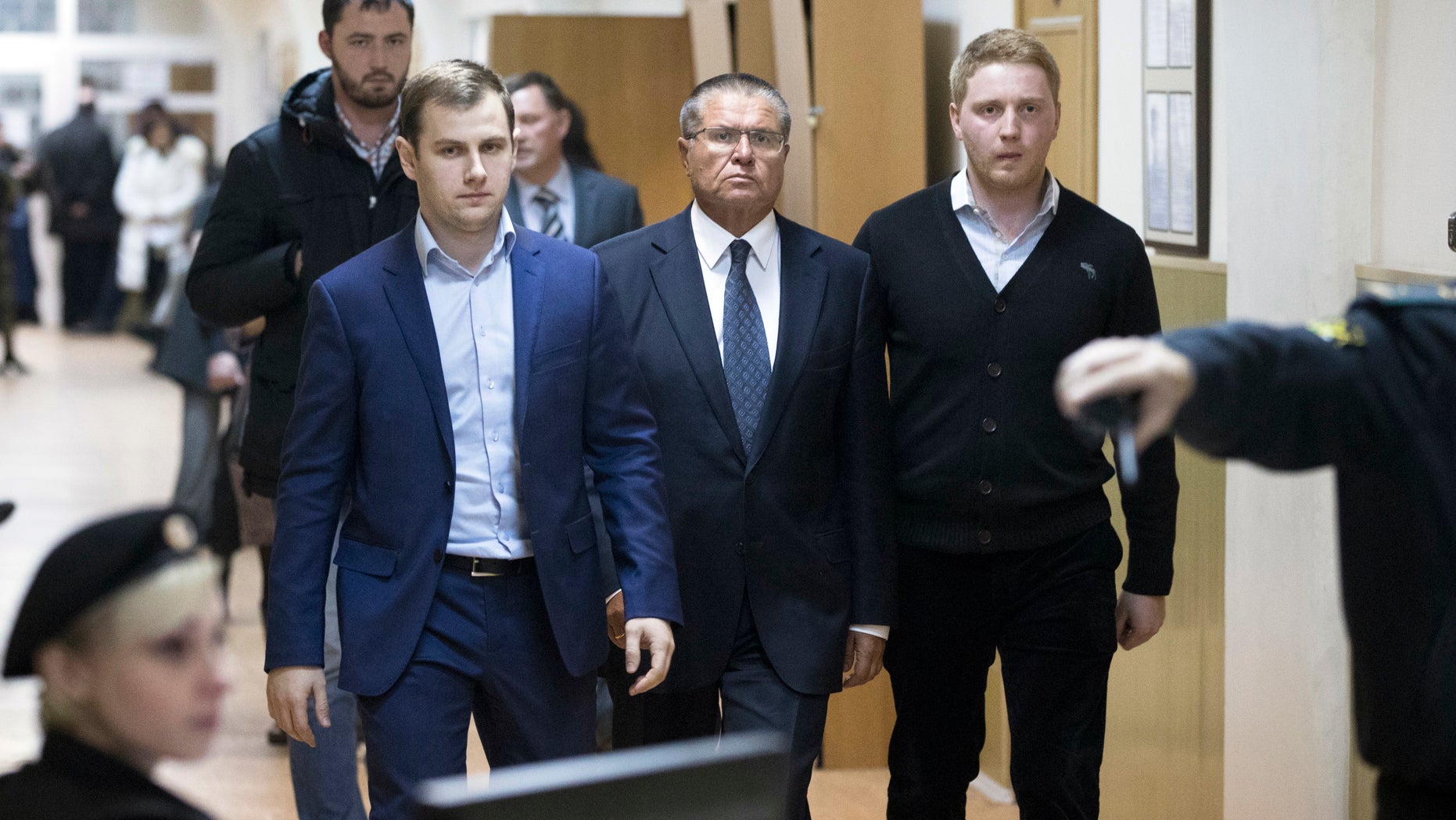 Russian Economic Development minister Alexei Ulyukayev, center, escorted to a court room in Moscow on Tuesday.