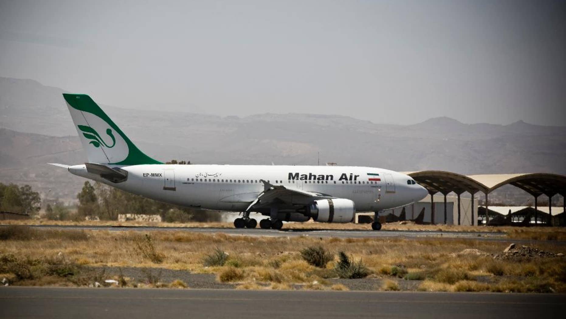 FILE - In this March 1, 2015 file photo, a plane from the Iranian private airline, Mahan Air lands the international airport in Sanaa, Yemen. An Iranian airline backed by the country’s notorious Revolutionary Guard has acquired rights to fly commercial routes in more than a dozen European and Asian countries in spite of U.S. terror-related sanctions, the same airline that ferries weapons and fighters to Syria on behalf of President Bashar Assad. (AP Photo/Hani Mohammed, File)
