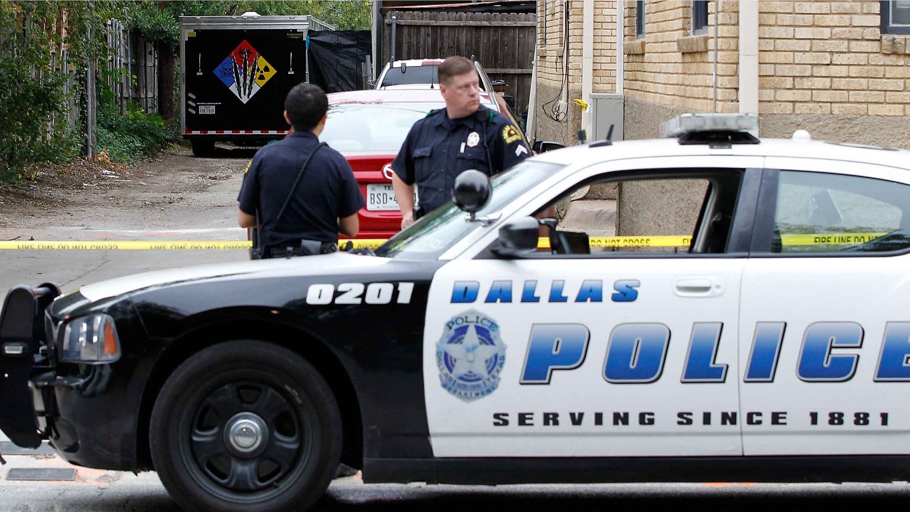 DALLAS, TX - OCTOBER 12: Dallas police setup a barrier after a hazmat vehicle entered the alley behind the apartment where a second person diagnosed with the Ebola virus resides on October 12, 2014 in Dallas, Texas. A female nurse working at Texas Heath Presbyterian Hospital, the same facility that treated Thomas Eric Duncan, has tested positive for the virus. (Photo by Mike Stone/Getty Images)