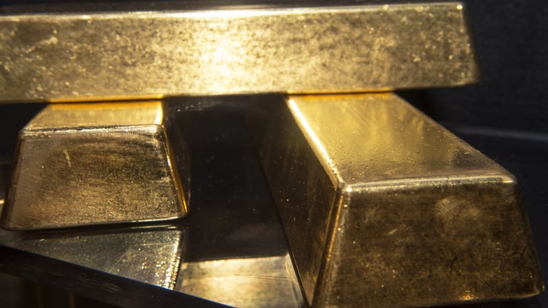 Three gold bullion bars with a combined value of more than $2 million on display at the Bureau of Engraving and Printing in Washington, on August 27, 2012