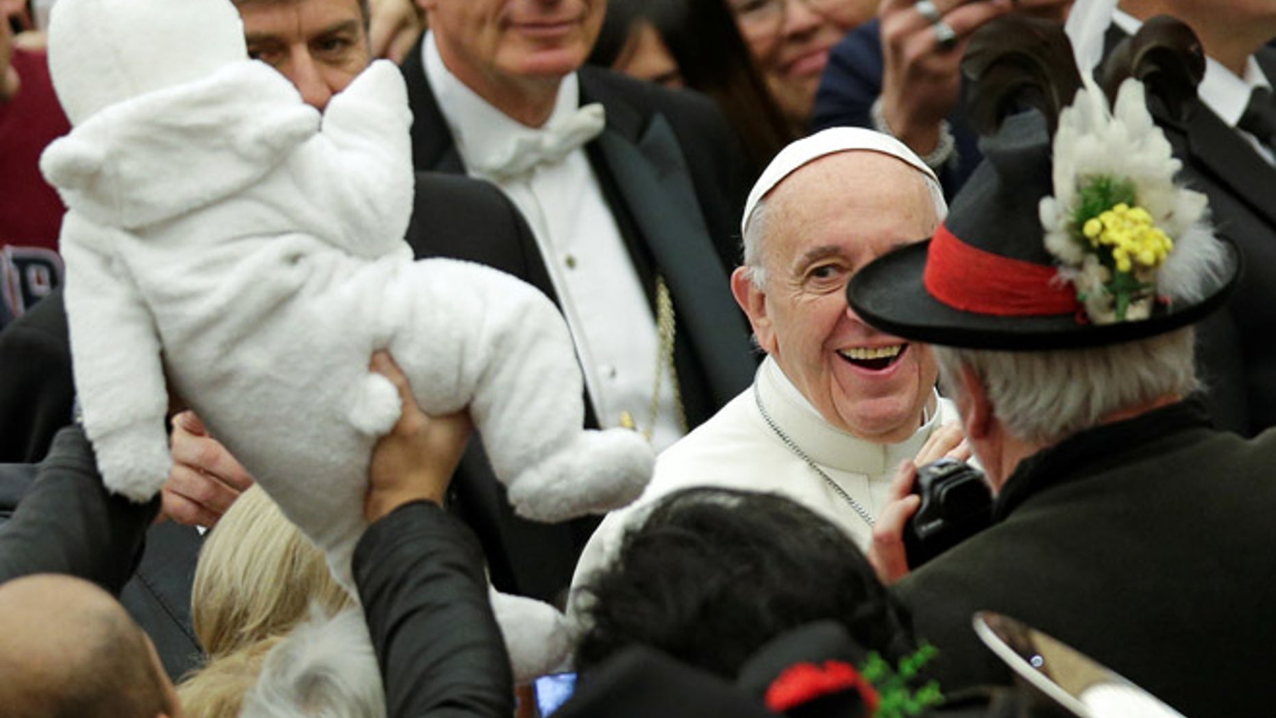 DEC. 7: Pope Francis smiles to a baby as he arrives to lead the general audience in Paul VI Hall at the Vatican