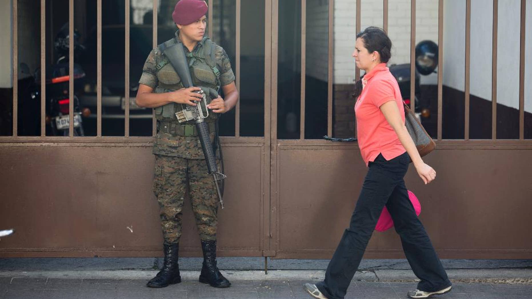 A Guatemalan soldier stands guard in front of the Presidential House in Guatemala City, Tuesday, Aug. 25, 2015. The Supreme Court took the first step in allowing impeachment proceedings against Guatemalan President Otto Perez Molina in a fraud scandal that is pushing the country into political crisis. (AP Photo/Moises Castillo)