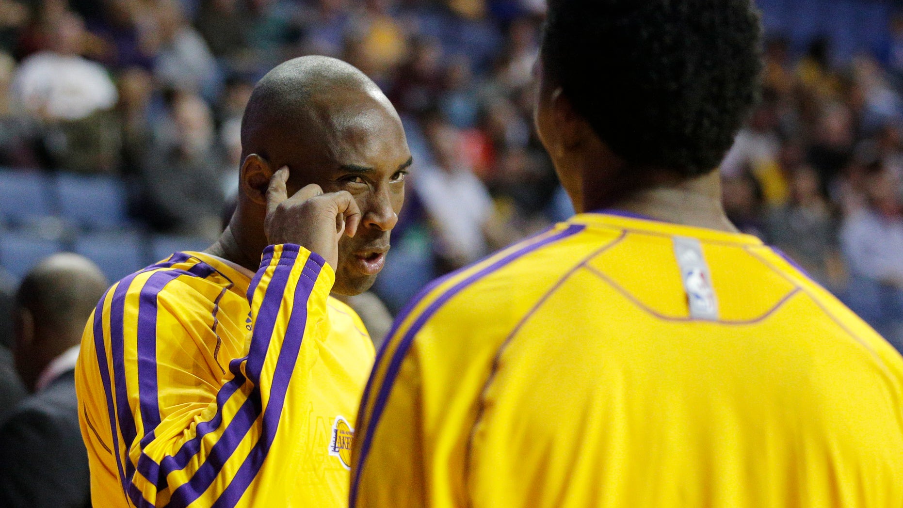 Los Angeles Lakers' Kobe Bryant, left, talks to Nick Young before an NBA preseason basketball game against the Denver Nuggets on Tuesday, Oct. 8, 2013, in Ontario, Calif. (AP Photo/Jae C. Hong)