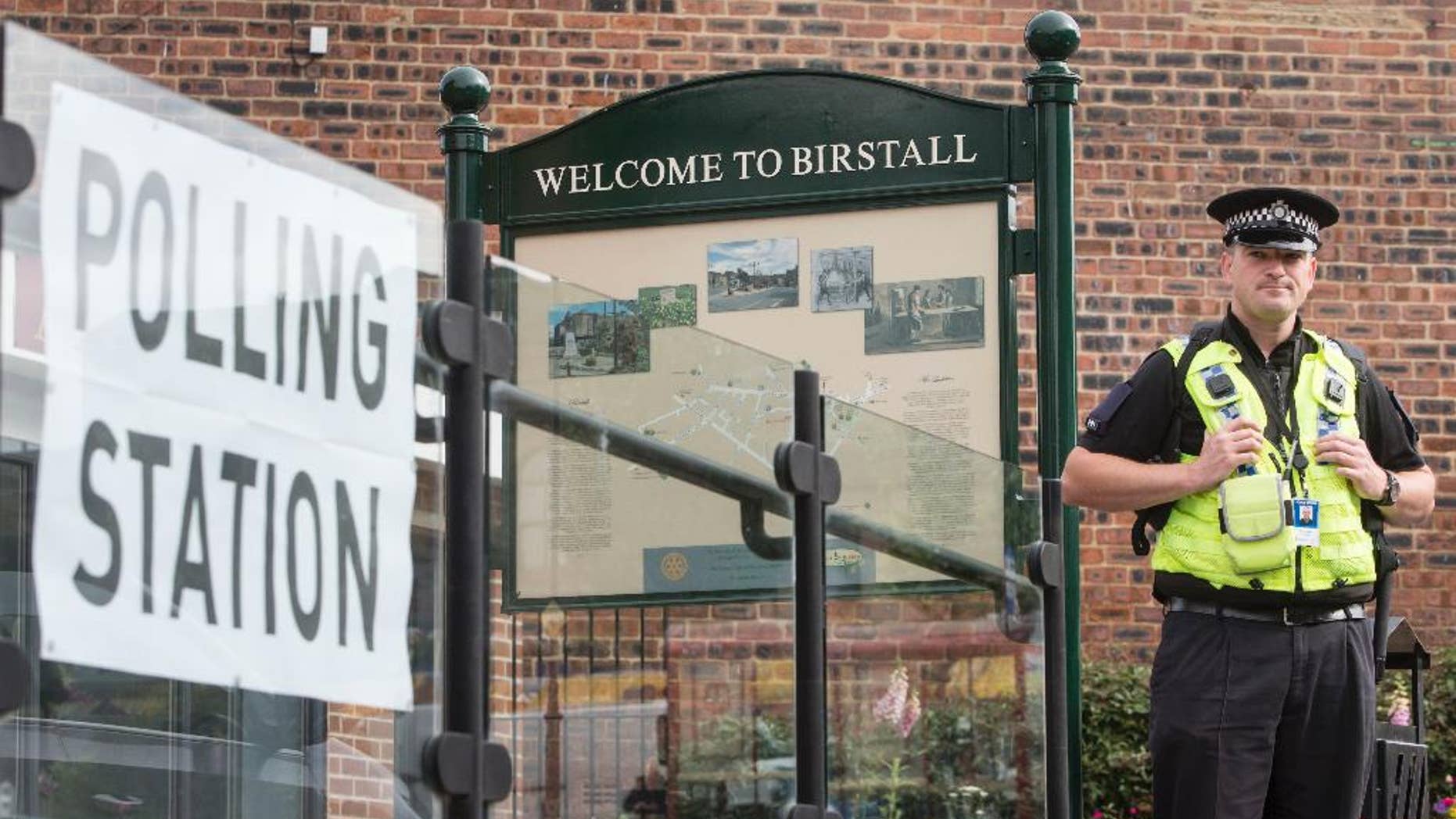A police officer stands outside a polling station being used in the EU referendum at Birstall library, West Yorkshire, England Thursday June 23, 2016 near to where Labour MP Jo Cox was attacked and killed outside her constituency surgery. Voters in Britain are deciding Thursday whether the country should remain in the European Union. (Danny Lawson/PA via AP) UNITED KINGDOM OUT - NO SALES - NO ARCHIVE