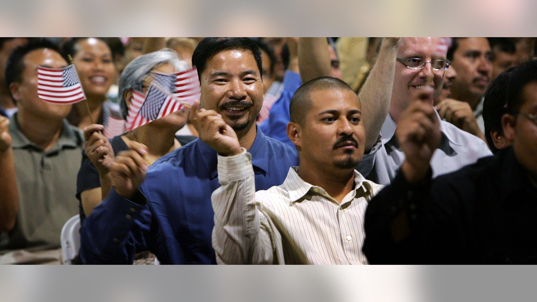 POMONA, CA - JULY 26: Immigrants wave flags after being sworn in as U.S. citizens in naturalization ceremonies on July 26, 2007 in Pomona, California. Some of the 6,000 people taking their citizenship oath are part of a flood of immigrants trying to beat a July 30 deadline when the cost of becoming a citizen goes up. First-time green card will go from $325 to $1,010, temporary resident status will increase from $255 to $710, and naturalization will cost $300 more. To meet the flood of immigrant applications, immigration offices had to extend their office hours. (Photo by David McNew/Getty Images)