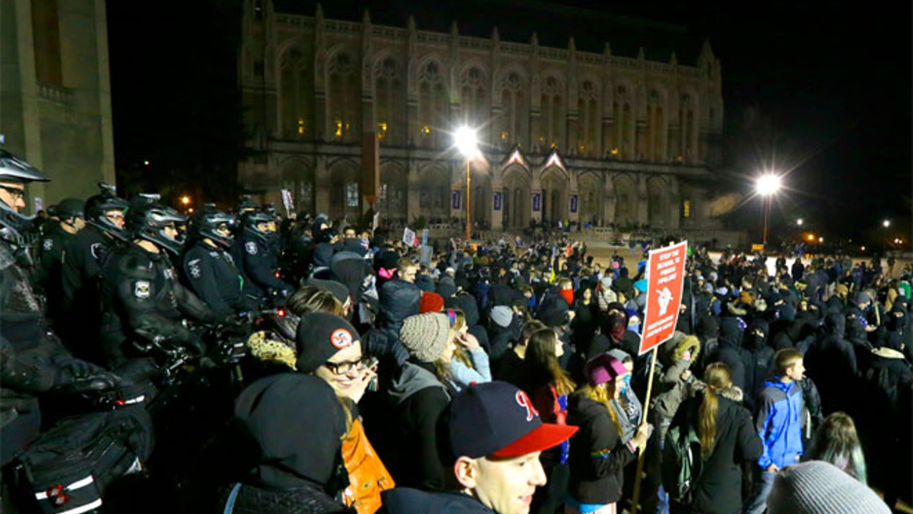 Protesters and police gather in front of Kane Hall on the University of Washington campus where far-right commentator Milo Yiannopoulos was giving a speech