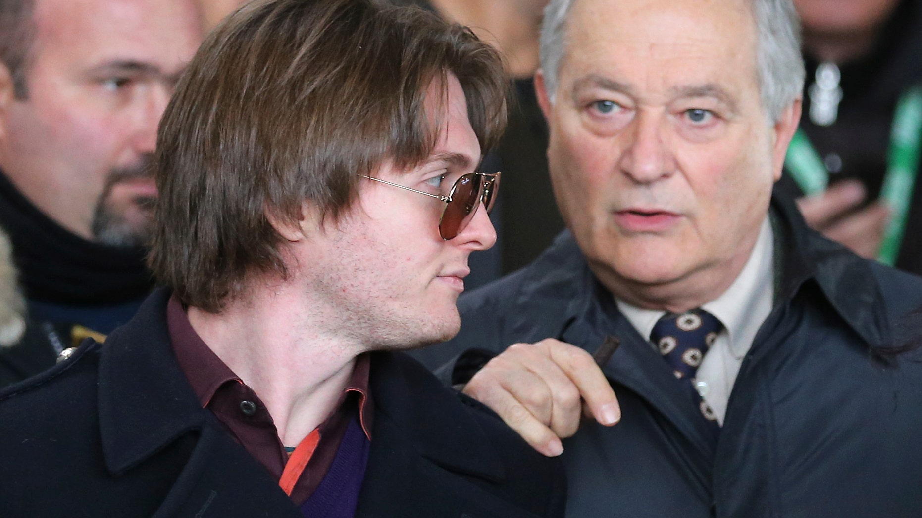 Raffaele Sollecito, left, and his father Francesco leave after attending the final hearing before the third court verdict for the murder of British student Meredith Kercher, in Florence, Italy, Thursday, Jan. 30, 2014. The first two trials produced flip-flop verdicts of guilty then innocent for Kercher former roommate, American student Amanda Knox, who is not attending the hearing, and her former Italian boyfriend, Raffaele Sollecito, and the case has produced harshly clashing versions of events. A Florence appeals panel designated by Italy's supreme court to address issues it raised about the acquittal is set to deliberate Thursday, with a verdict expected later in the day. (AP Photo/Antonio Calanni)