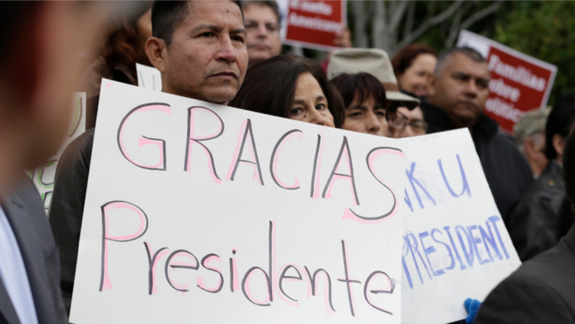 Sebastian Montalvan, left, who has been living in the country illegally, joined dozens of others who are here illegally, as well as activists and supporters to celebrate President Barack Obama's executive action on illegal immigration, at a at a news conference in Sacramento, Calif., Friday, Nov. 21, 2014.(AP Photo/Rich Pedroncelli)