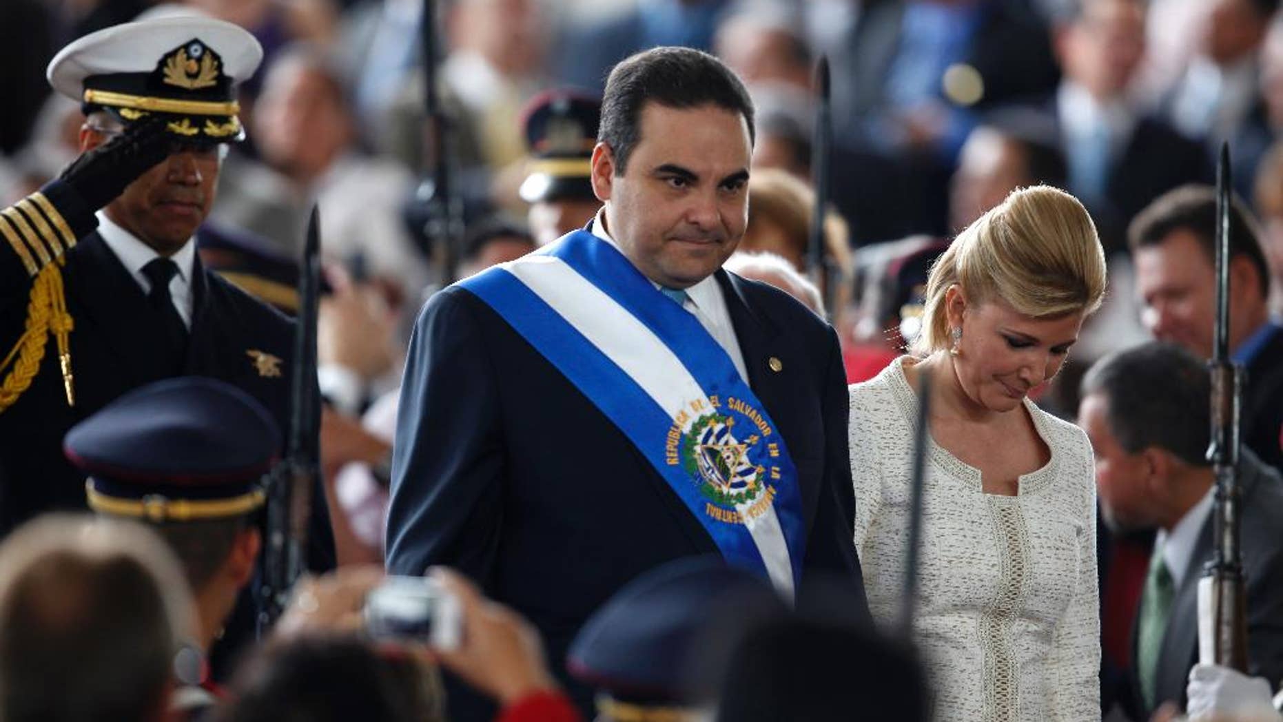 FILE - In this June 1, 2009, file photo, on his last day as President of El Salvador, Tony Saca and his wife, Ana Ligia de Saca, arrive at the inauguration ceremony of the new president of El Salvador Mauricio Funes in San Salvador. Prosecutors said Saturday, Oct. 29, 2016, that Ex-President Saca has been arrested for alleged illicit enrichment, unlawful association and money laundering. (AP Photo/Dario Lopez-Mills, File)