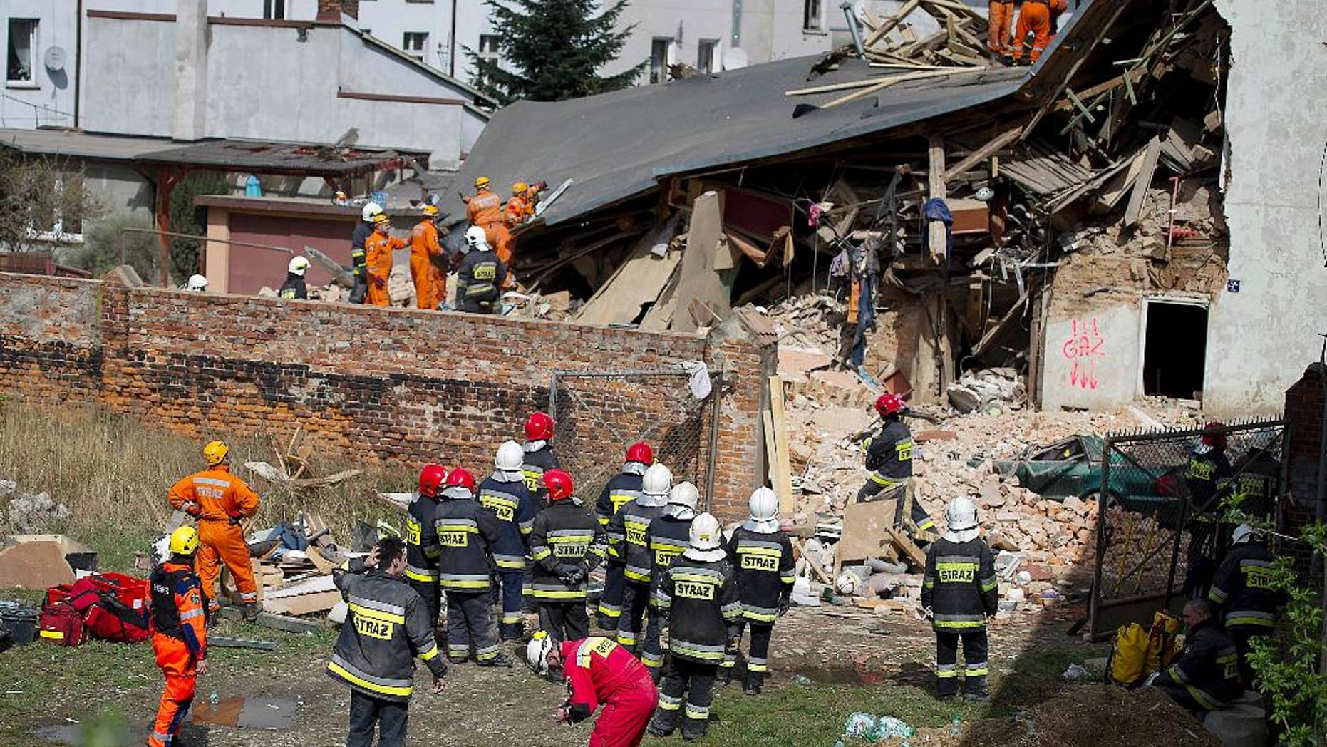 Rescuers and firefighters search for 11 missing people in the rubble of an apartment house that collapsed in Swiebodzice, Poland, on Saturday, April 8, 2017. Firefighters suspect the collapse might have been caused by a gas explosion. Several people were killed and injured. (AP Photo)