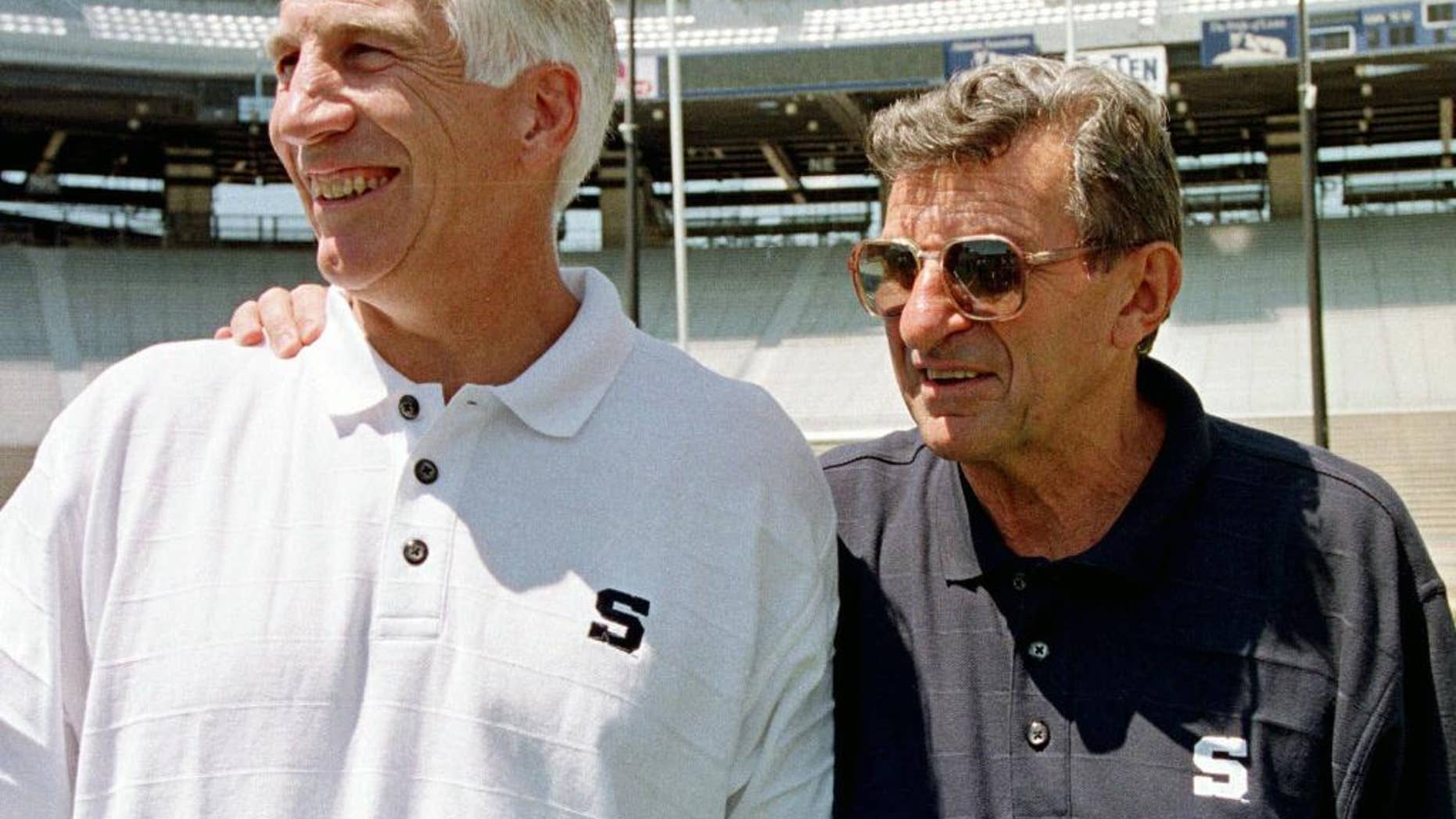 Jerry Sandusky, left, stands with Penn State football coach Joe Paterno.