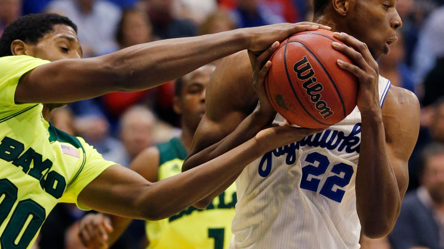 Baylor forward Royce O'Neale (00) tries to take the ball from Kansas guard Andrew Wiggins (22) during the second half of an NCAA college basketball game in Lawrence, Kan., Monday, Jan. 20, 2014. Kansas defeated Baylor 78-68. (AP Photo/Orlin Wagner)