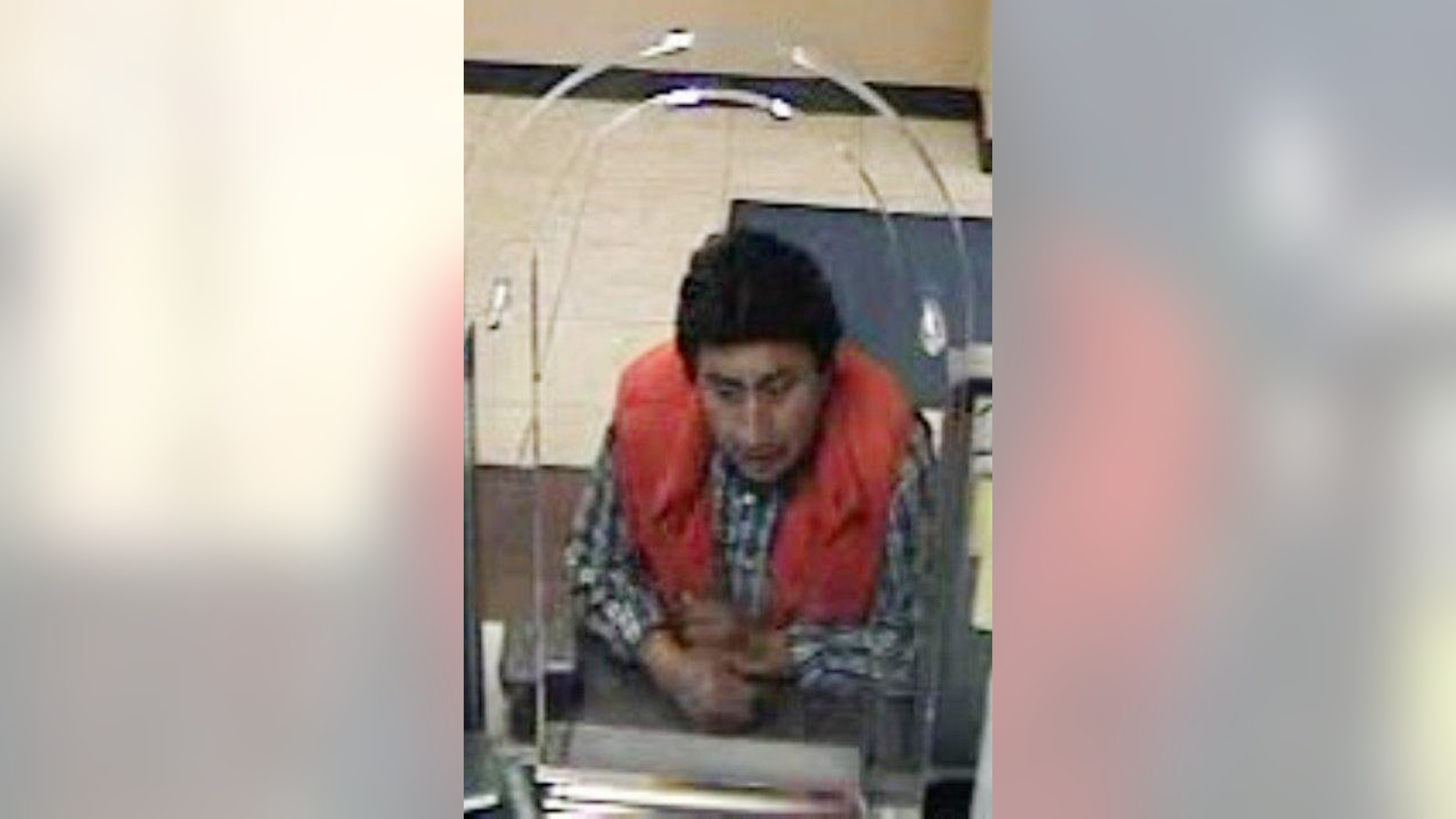 In this image taken from surveillance video and provided by the New York City Police Department, an unidentified man who tries to withdraw funds from the bank account of New York City accountant Pedro Portugal is shown. Portugal was snatched from a city street in broad daylight, and then held captive for more than a month in an attempt to extort ransom from his family in Ecuador. Detectives rescued Portugal on May 20 after noticing a light upstairs in an otherwise dark Queens, N.Y. warehouse. (AP Photo/New York City Police Department)